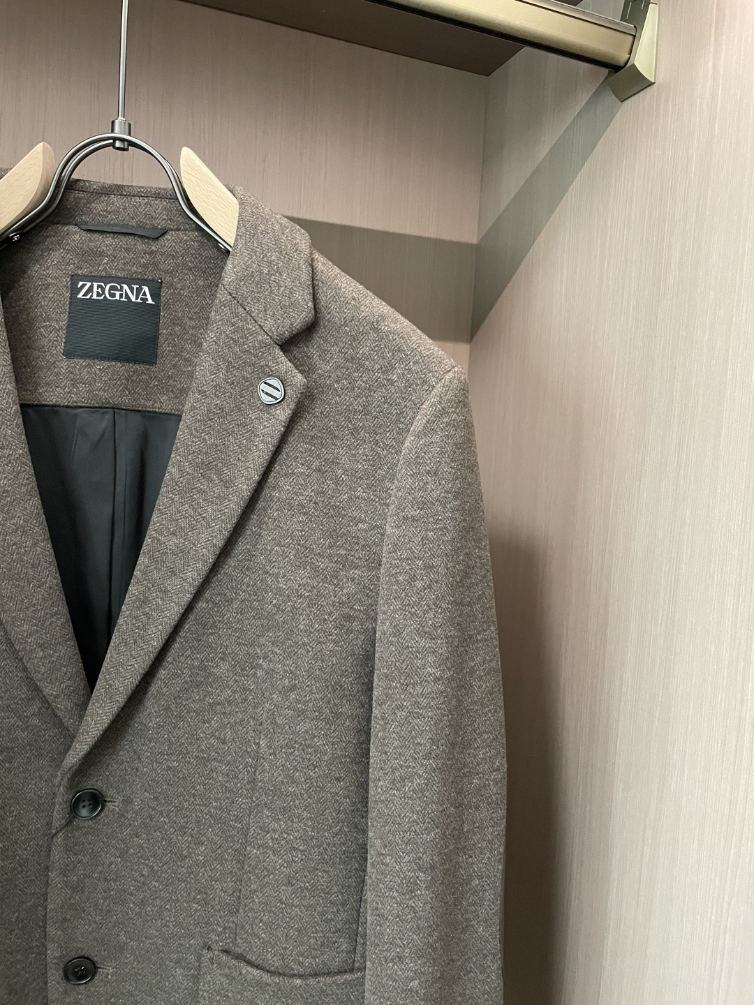 这款杰尼亚羊毛西装，是商务绅士的“质感名片”！精选细腻羊毛面料，浅咖色人字纹肌理自带低调奢华感，在光线里