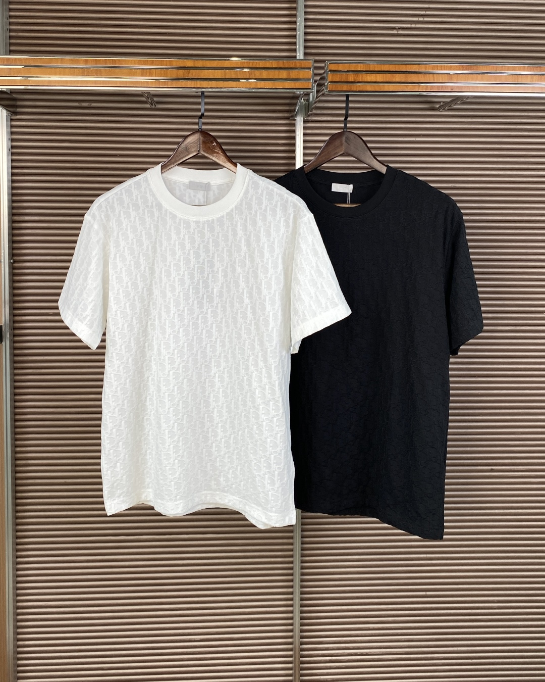 NO:833898,Dior's iconic Oblique jacquard short-sleeved T-shirt. 1. Core design and logo Brand logo There is the Dior brand logo on the neckline, and a hangtag with the word 'Dior' hanging on the chest. The jacquard pattern is made of Dior's iconic Oblique diagonal jacquard throughout the body, presented through the jacquard process, low-key and highly recognizable, and is the most representative visual symbol of the brand.  The classic round neck and loose straight fit are not too picky about your body shape, taking into account daily comfort and high-end feeling. The same style for men and women. The colors are white and black, both versatile basic colors, suitable for different styles. 2. Fabric and technology: The fabric is cotton jacquard fabric, which is soft and skin-friendly, and has a certain degree of stiffness and is not easy to collapse. The craftsmanship is woven into the fabric through precision jacquard technology instead of printing, so the pattern is durable and will not fall off with washing, and the details reflect the luxury texture.  For daily casual wear, pair with straight jeans, casual trousers or overalls, and white shoes or loafers to easily create a relaxed and high-end look. Pair it with a shirt or knitted cardigan of the same brand to expose the collar and presbyopic details, which is suitable for the transition season between spring and autumn. Accessories echo the brand style and can be paired with Dior Oblique belts, tote bags or small leather goods to enhance the overall look.,, dior, dior, loafers, totes, jeans, shirts, T-shirt,19860909Dior（迪奥） 标志性的Oblique 提花短袖 T 恤. 1. 核心设计与标识 品牌标识领口处有 Dior 品牌标,胸前悬挂着印有“Dior”字样的吊牌. 提花图案全身采用 Dior 标志性 Oblique 斜向提花,通过提花工艺呈现,低调且极具辨识度,是品牌最具代表性的视觉符号. 版型经典圆领、宽松直筒版型,不挑身材,兼顾日常舒适与高级感,男女同款. 颜色白色与黑色两款,均为百搭的基础色,适合不同风格搭配. 2. 面料与工艺 面料棉提花面料,触感柔软亲肤,同时具备一定的挺括度,不易软塌. 工艺通过精密提花工艺织入面料,而非印花,因此图案持久耐磨,不会随洗涤脱落,细节体现奢侈品质感. 日常休闲搭配直筒牛仔裤、休闲西裤或工装裤,脚踩小白鞋或乐福鞋,轻松营造松弛感高级穿搭. 叠穿造型内搭在同品牌衬衫或针织开衫内,露出领口与老花细节,适合春秋过渡季. 配饰呼应可搭配 Dior Oblique 腰带、托特包或小皮具,强化整体造型的品牌风格.,,dior,dior,loafers,totes,jeans,shirts,T-shirt,,Women's clothing