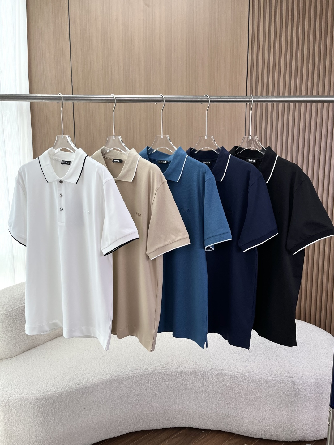 NO:826120,ZEGNA Men's Contrast Collar Stretch Piqué Cotton POLO Shirt 1. Style and Design Style Positioning Zegna 2026 spring and summer classic men's business casual POLO shirt, featuring contrasting thin edge lapel + cuff trim design, is the brand's iconic high-luxury commuter style. The color selection provides 5 basic colors of white (black edge), lake blue (white edge), black (white edge), khaki (white edge), and navy blue (white edge), suitable for different wear styles  The silhouette is slightly loose and has a shoulder cut, which is not too picky and is suitable for business and leisure scenarios. Design highlights: Three-button placket with natural shell buttons, high-end texture. ZEGNA brand logo embroidered in the same color on the left chest, low-key to show identity. Contrast color thin edge lapel + same color trim on the cuffs, enhance the sense of layering and not easy to deform. Pique mesh fabric, breathable and skin-friendly, with micro-elastic properties 2. Fabric and technology Fabric composition: 95 cotton +  5 spandex (elastic piqué cotton) The cotton material is made of high-count combed cotton, which is soft and skin-friendly, breathable and anti-wrinkle. 5 spandex provides moderate elasticity, no restrictions on movement, and is not easy to deform after long-term wear. Process details: Imported machine hidden embroidery process, brand logo embroidery thread is neat, invisible and not obtrusive. Computer positioning sewing, even routing, and shaping treatment on the collar. Three labels are complete (collar label, hang tag, wash mark), and the hang tag adopts the brand's iconic red and black contrasting design. Wearing suggestions  1. For business commuting scenes, choose white, navy blue or black styles, match them with drapey trousers or casual trousers, and wear loafers or derby shoes. You can wear them with a suit jacket of the same color to create a formal but not rigid light business look, suitable for formal occasions such as offices and business negotiations. 2. Daily casual scenes  The lake blue and khaki colors are the most suitable. Pair them with straight jeans, casual shorts, white shoes, sneakers or ethics shoes to create a relaxed daily wear. Suitable for weekend outings, gatherings with friends, daily shopping, etc. 3. Light business travel scenarios  Black and khaki colors are the first choice. Pair with nine-point casual trousers and white shoes or casual leather shoes. No need to wear a suit. It takes into account both business sense and comfort. It is suitable for commuting, short-distance business trips, informal business meetings and other scenes. 4. Layer styling scenarios  Any color scheme is available. Pair it with a solid color shirt and expose the lapels of the POLO shirt to create a layered look. Pair the bottoms with trousers or casual pants. It is suitable for spring and autumn seasons and is suitable for business commuting, daily outings and other scenarios.,,zegna,loafers,shorts,jeans,jackets & coats,shirts,business suit,19860909ZEGNA（杰尼亚）男士撞色领弹力珠地棉POLO衫 1. 款式与设计 款式定位杰尼亚2026春夏经典款男士商务休闲POLO衫,主打撞色细边翻领+袖口饰边设计,是品牌标志性的高奢通勤款 配色选择提供白色（黑边）、湖蓝（白边）、黑色（白边）、卡其（白边）、藏青（白边）5款基础色,适配不同穿搭风格 版型剪裁微宽松正肩剪裁,不挑身材,适配商务、休闲多场景 设计亮点 三粒扣门襟,搭配天然贝壳扣,质感高级 左胸同色系暗绣ZEGNA品牌标识,低调彰显身份 撞色细边翻领+袖口同色饰边,提升层次感,不易变形 珠地网眼面料,透气亲肤,自带微弹属性 2. 面料与工艺 面料成分95棉 + 5氨纶（弹力珠地棉） 棉料采用高支数精梳棉,柔软亲肤、透气抗皱 5氨纶提供适度弹力,活动无束缚,久穿不易变形 工艺细节 进口机暗绣工艺,品牌标识绣线工整、隐形不突兀 电脑定位缝纫,走线均匀,领口做定型处理 三标齐全（领标、吊牌、洗水标）,吊牌采用品牌标志性红黑撞色设计 穿搭建议 1. 商务通勤场景 选择白色、藏青色、黑色款,搭配垂感西裤或休闲西裤,脚踩乐福鞋、德比鞋,可外搭同色系西装外套,打造正式又不刻板的轻商务造型,适配办公室、商务洽谈等正式场合. 2. 日常休闲场景 湖蓝色、卡其色款适配度最高,搭配直筒牛仔裤、休闲短裤,脚踩小白鞋、板鞋或德训鞋,打造松弛感日常穿搭,适合周末出游、朋友小聚、日常逛街等场景. 3. 轻商务出行场景 黑色、卡其色款为首选,搭配九分休闲西裤,脚踩小白鞋或休闲皮鞋,无需外搭西装,兼顾商务感与舒适度,适配通勤、短途出差、非正式商务会面等场景. 4. 叠穿造型场景 任意配色款均可,内搭纯色衬衫,将POLO衫翻领外露,打造层次感造型,下装搭配西裤或休闲裤,适配春秋季节,适合商务通勤、日常出街等多场景.,,zegna,loafers,shorts,jeans,jackets & coats,shirts,business suit,,Women's clothing