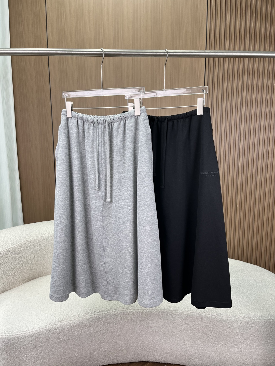 NO:861942,(Welfare) Alexander Wang Alexander Wang embroidered letter drawstring sweatshirt dress casual A-line mid-length skirt!  The Alexander Wang letter logo is low-key embroidered on the side seam of the skirt. The same color craftsmanship is simple yet recognizable. The details are eye-catching and can easily create a casual and relaxed street style. Fabrics and technology  Selected high-weight, skin-friendly terry fabrics are soft and breathable, making the upper body comfortable and comfortable, with a lazy atmosphere; the fabric is wrinkle-resistant and not easy to deform, and it can maintain a neat silhouette after long-term wear; precision sewing technology, neat line routing, smooth edge seams, durable and not easy to fall off. Highlights of version and design: Elastic waist + drawstring design, high elastic elastic waist with adjustable drawstring, accommodates a variety of waist sizes, easy to put on and take off without tightening the waist, and easily fits the body shape;  The A-line mid-length and loose A-line skirt can effectively modify short body parts such as hip width and thick legs, and has an excellent slimming effect, giving you a sense of elegance when walking; Practical zipper side pockets with hidden zipper pockets on the side, taking into account both beauty and practicality, can be used to store small items, making daily travel more convenient; Simple solid color design, two classic colors of light gray and pure black, without unnecessary complicated decorations, can easily adapt to a variety of styles, making it a must-have and versatile item in the wardrobe. Style adaptation  Whether it is paired with a short top to create a sexy street girl style, or paired with a sweatshirt or T-shirt to create a casual daily look, it can be easily controlled and suitable for daily life, commuting, vacation and other scenarios.,,alexander wang, hoodie, sweatshirts, skirts, tees, t-shirt,19860909（福利） Alexander Wang 亚历山大王刺绣字母抽绳卫衣裙 休闲A字中长半身裙！ 裙身侧缝低调刺绣Alexander Wang字母标识,同色系工艺简约又不失辨识度,细节控一眼心动,轻松打造随性松弛的街头风格. 面料与工艺 甄选高克重亲肤毛圈面料,柔软透气,上身舒适自在,自带慵懒氛围感；面料抗皱不易变形,久穿依旧保持利落版型；精密车缝工艺,走线工整,边缘锁边平整,耐穿不易脱线. 版型与设计亮点 松紧腰头+抽绳设计高弹力松紧腰搭配可调节抽绳,包容多种腰围,穿脱便捷不勒腰,轻松贴合身形； A字中长版型宽松A字裙摆,有效修饰胯宽、腿粗等身材短板,藏肉显瘦效果出众,行走间自带飘逸感； 实用拉链侧袋侧边隐形拉链口袋,兼顾美观与实用性,可放置随身小物,日常出行更便捷； 简约纯色设计浅灰、纯黑两款经典色系,无多余繁杂装饰,轻松适配多种穿搭风格,是衣橱必备的百搭单品. 风格适配 无论是搭配短款上衣打造又A又飒的街头辣妹风,还是搭配卫衣、T恤打造休闲日常造型,都能轻松驾驭,适配日常、通勤、度假等多种场景.,,alexander wang,hoodie,sweatshirts,skirts,tees，t-shirt,,Women's clothing