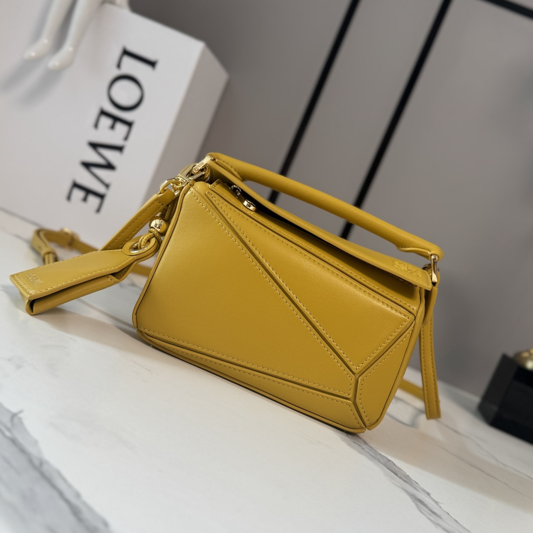NO:879750,LOw's new mini Nappa sheep leather Featherlight Puzzle handbag outlines a rectangular shape with unique geometric lines. The soft and lightweight Nappa leather injects a casual and lazy style into the handbag. It can be carried on the shoulder, cross-body or handheld. Detachable and adjustable shoulder strap, decorated with rotating buckle*zipper closure, hinged zipper puller. One external zipper back pocket, one internal slip pocket*removable LOE**WE  Hot stamping or silvering label, decorated with secret pockets and balloon dice* Rectangular metal feet Nappa sheep leather lining Anagram embossing, plaque engraved inside LOE**WE. Model 062511 size: 17.5*7.5*12.5CM (with full package), sheepskin-nubuck leather New geometric bag, loewe, sheepskin19860909LOw新款 迷你纳帕羊皮革 Featherlight Puzzle 手袋 以别具一格的几何线条勾勒长方体造型.柔软轻盈的纳帕皮革为手袋注入随性慵懒的风格.可肩背、斜挎或手提 可拆卸可调节肩带,饰有旋转卡扣*拉链开合,铰接式拉链头 一个外部拉链后袋,一个内部插袋*可拆卸 LOE**WE 烫金或烫银标签,饰有隐秘口袋和气球骰子*长方形金属脚钉 纳帕羊皮革衬里 Anagram 压纹、饰牌内部镌刻 LOE**WE. 型号062511 size:17.5*7.5*12.5CM（配全套包装）,羊皮—牛巴革 新款几何包,loewe,sheepskin,Bag