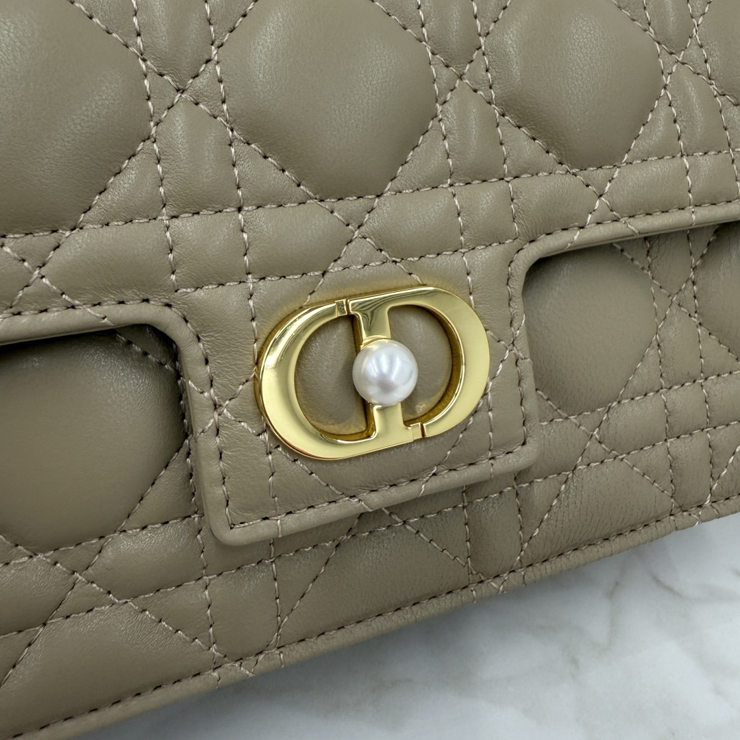 这款 Dior Jolie 迷你链条手袋是二零二五秋冬成衣系列新品，兼具优雅气质与实用功能。采用奶茶杏羊皮革精心制作，搭配藤格纹缉面线，翻盖饰以点缀白色树脂珠饰的复古金色饰面金属CD 标志。内设一个隔层，可收纳各种用品。搭配可调节、可拆卸CD链环肩带，穿插点缀以白色树脂珠饰，饰以皮革带，可搭配日常造型或晚装舒适手提、肩背或斜挎。 
主体:羊皮革 
里料:羊皮革，科技面料 正面CD 扣环饰以白色树脂珠饰翻盖开合内部插袋6 个卡槽 饰以树脂珠饰和皮革带的可调节、可拆卸链条肩带内含防尘袋意大利制造 
尺寸：21cm×11.5cm×4.5cm 
编号：S3117