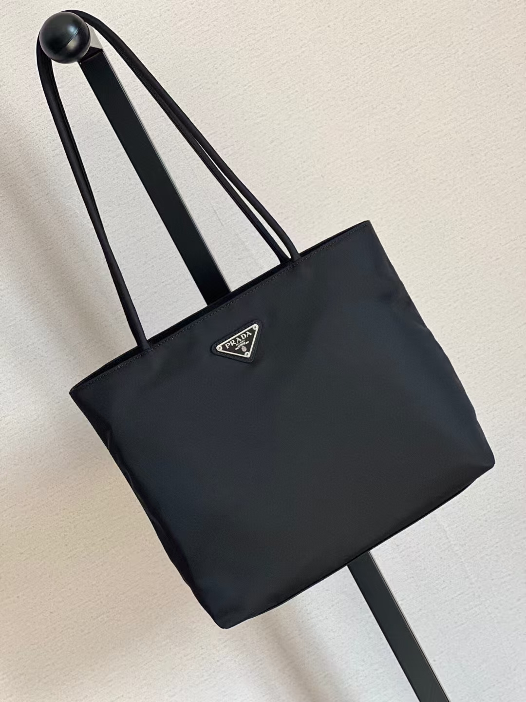 Original product from Prada, easy to carry, very light, and the nylon material is very durable and will last almost forever!