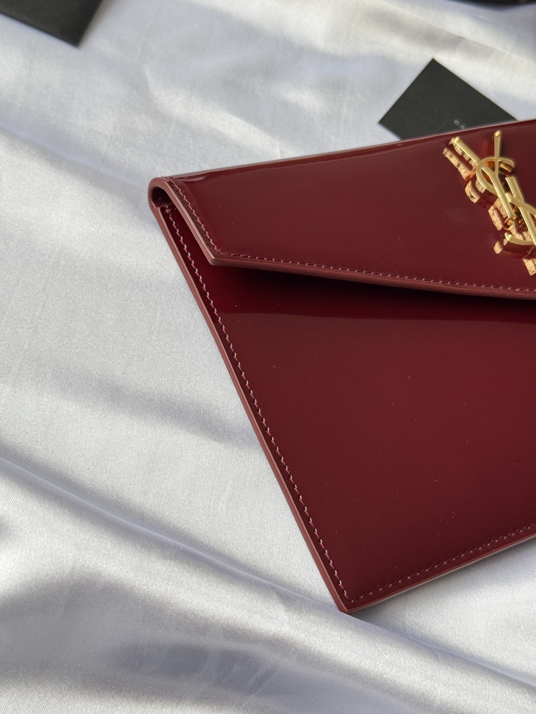 Saint Laurent Paris Clutch in Burgundy Patent Leather with Gold Logo 4 cmp i1743756904144 5166 0 3