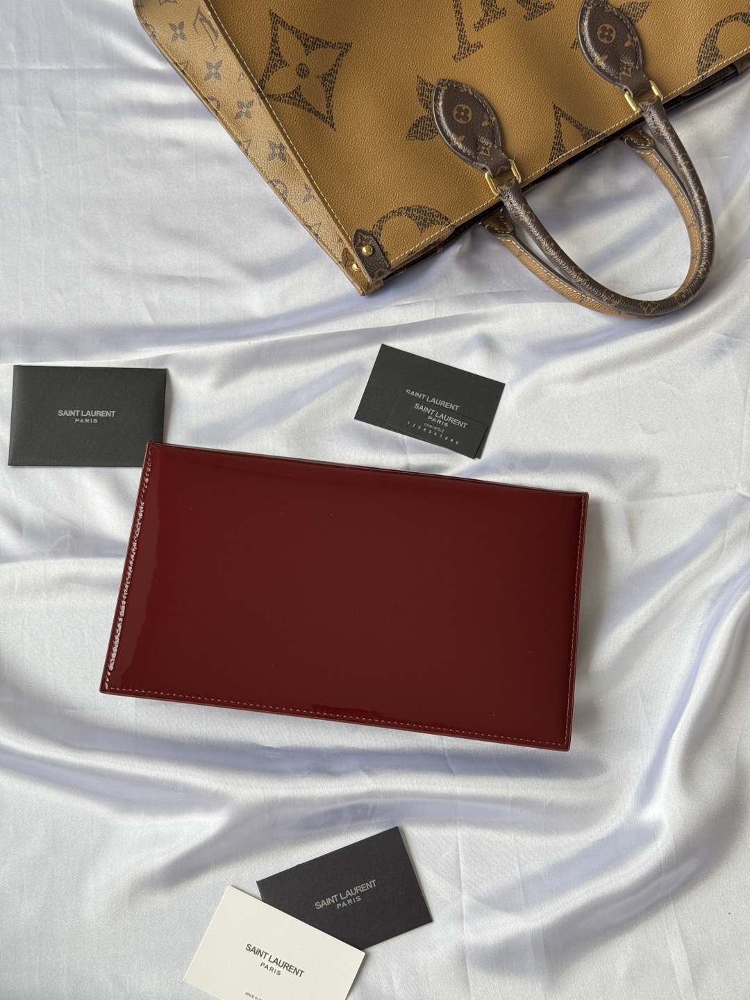 Saint Laurent Paris Clutch in Burgundy Patent Leather with Gold Logo 2 cmp i1743756904145 9832 0 1