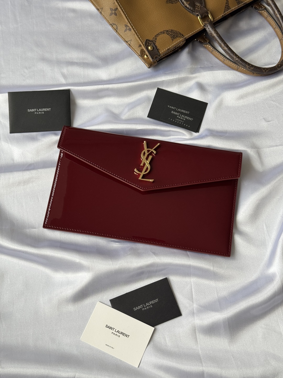 Saint Laurent Paris Clutch in Burgundy Patent Leather with Gold Logo 1 cmp i1743756910158 135 0 0
