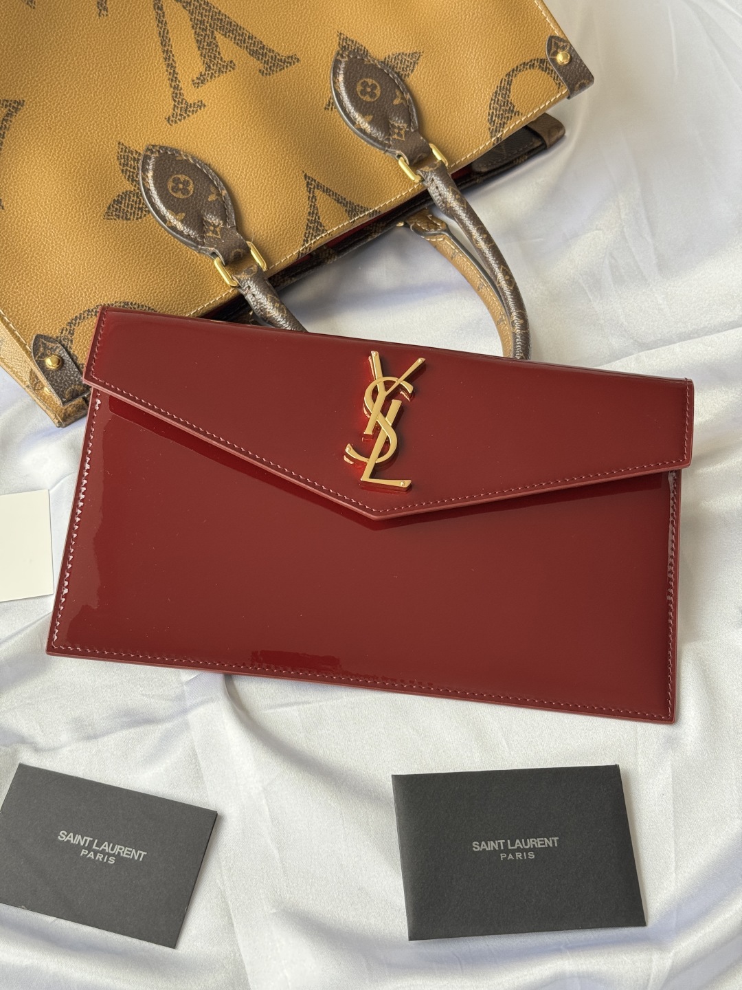Saint Laurent Paris Clutch in Burgundy Patent Leather with Gold Logo 9 cmp i1743756910177 3707 0 8