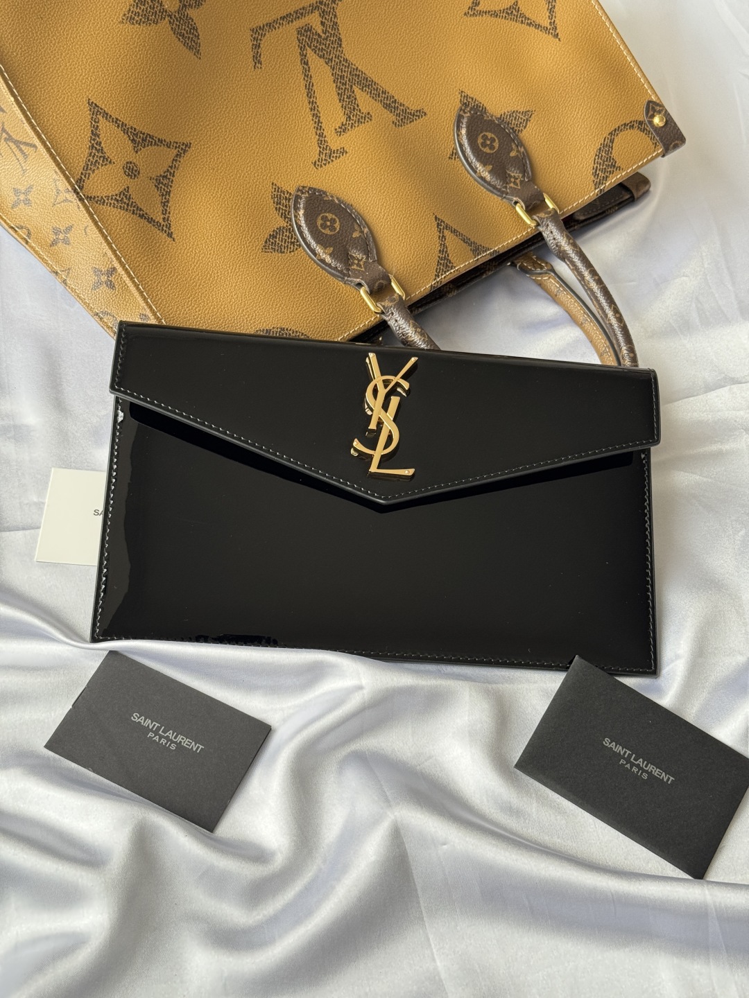 Yves Saint Laurent Black Patent Leather Clutch with Gold Logo 3 cmp i1743757038290 2865 0 1