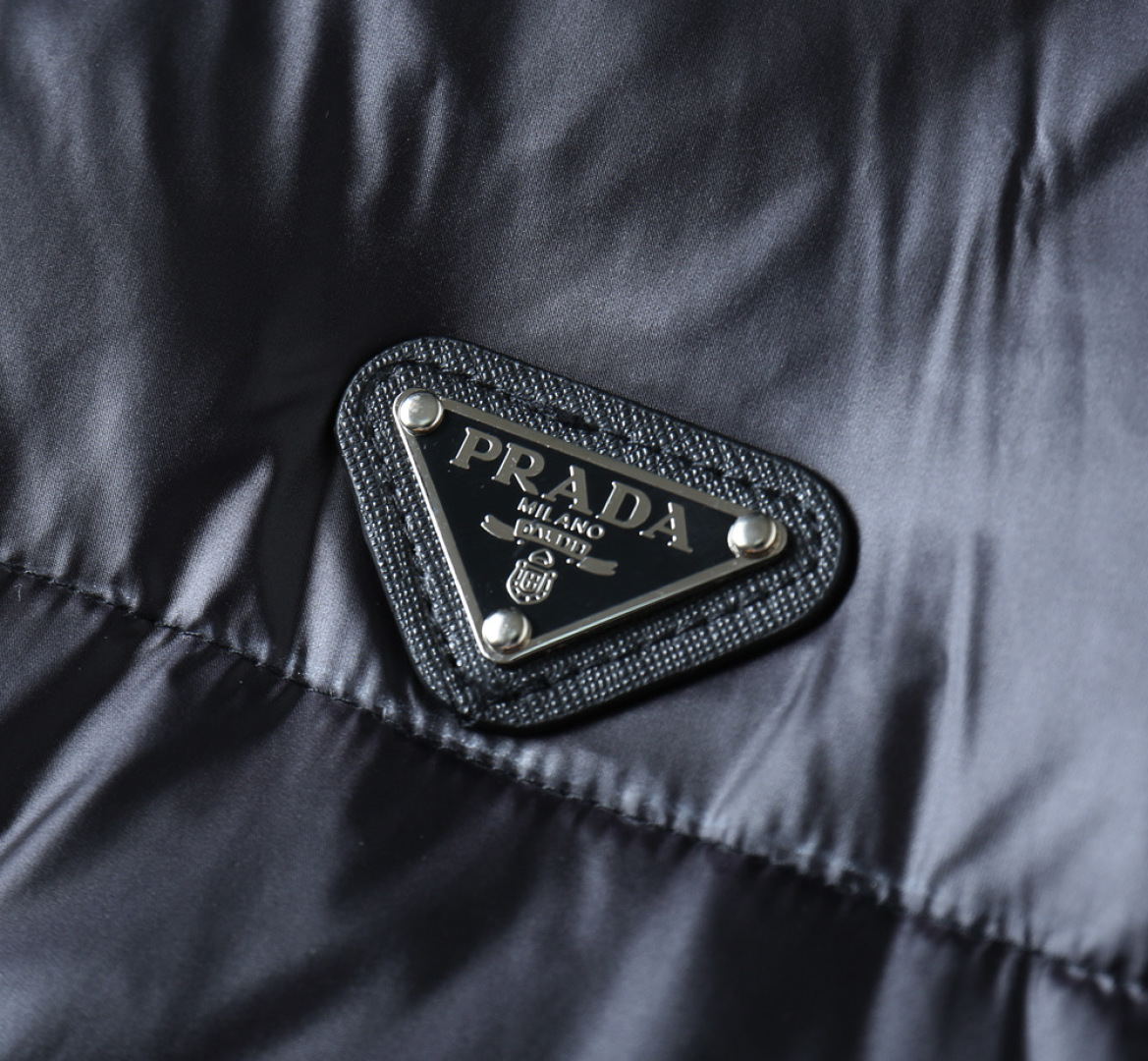 P570 普拉达 新款羽绒服。这款号称羽绒服届专业的，三标齐全全部90绒的。带着经典的Logo组合搭配，第一眼看到就是满满的视觉冲击，保暖性能更出色，轻便不厚重，且压缩后的蓬松度恢复性好，聚热锁温！个性的拼色设计，清新有活力！市面流通的版本实在太多了，除了面料做工不同外，最大的区别就是填充物根本不是鹅绒而是羽丝或手感绒等等，而不懂的根本不容易区分。另外面料和做工也绝对不是一个级别，总之认准我们，让你绝对不跑偏，独家全色全部购入正版开发，懂我们家羽绒服质量的，完全可以放心闭眼推。码数：M-3XL.最大穿到200斤左右。下单报身高体重。