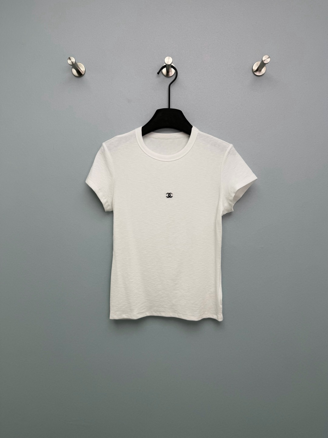 NO:777992,Chan*l26's new double C metal logo slim-fit short-sleeved T-shirt. The iconic double C logo is used on the chest. The metallic texture is high-end and the contrasting design (silver and black color matching) is highly recognizable and full of light luxury. Highly elastic and skin-friendly fabrics are breathable and not sweaty. It is super comfortable to wear in spring and summer. The double C metal logo on the chest is too delicate, giving it a low-key and light luxury feel. The white T is clean and refreshing, and the black T is cool and slim. Both colors are magical.  2 colors and 3 codes SML, Chanel-clothing, chanel, chanel, T-shirt, tees, t-shirt,19860909Chan*l26新款双C金属标修身短袖T恤 胸前采用标志性双C logo,金属质感高级,撞色设计（银黑拼色）辨识度拉满,轻奢感十足 高弹亲肤面料,透气不闷汗,春夏穿超舒服 胸口的双C金属标太精致了,低调轻奢感拉满 白T干净清爽,黑T酷飒显瘦,两色都封神 2色3码SML,香奈儿-服装,chanel,chanel,T-shirt,tees，t-shirt,,Women's clothing