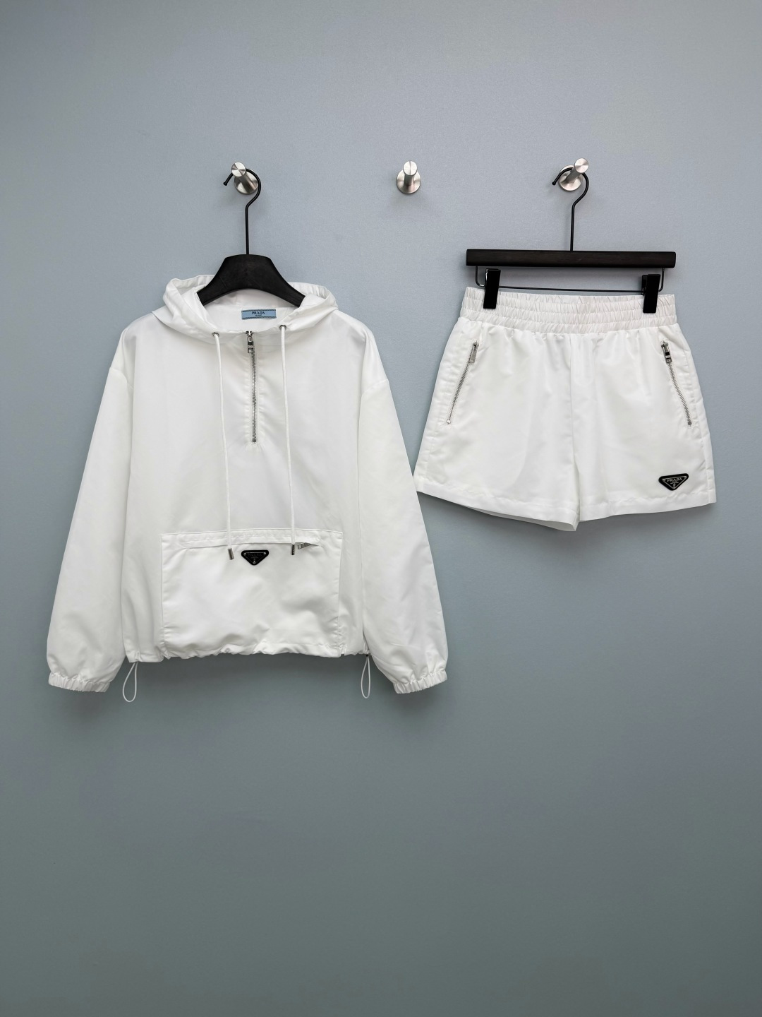 NO:781354,prad*26 new thin nylon sun protection casual hooded suit. A combination of half-zip pullover top and shorts. Environmentally friendly recycled materials, waterproof and anti-wrinkle, easy to take care of every day, refreshing and breathable for spring and summer. Classic hood to modify the shoulder and neck lines, half zipper and half placket, casual without losing design. Shorts with high elastic elastic waist, loose fit, not picky on the figure, comfortable. Large pockets on the top with Prada black triangle logo, low-key luxury, highlighting the brand quality.  Gentle ice blue and classic black are not picky on skin or occasion, and can be easily used for leisure and commuting. 2 colors and 3 codes SMLAB, Prada-clothing, prada, prada, shorts, hats,19860909prad*26新款薄款尼龙防晒休闲连帽套装 半拉链套头上衣短裤的组合 环保再生材质,防水抗皱,日常打理轻松,春夏穿着清爽透气 经典连帽修饰肩颈线条,半拉链半开襟,随性又不失设计感 短裤高弹松紧腰,宽松版型,不挑身材,舒适自在 上衣大口袋Prada黑色三角标,低调奢华,彰显品牌质感 温柔冰蓝色,经典黑两色不挑皮不挑场合,休闲通勤都能轻松驾驭 2色3码SMLAB,普拉达-服装,prada,prada,shorts,hats,,Women's clothing