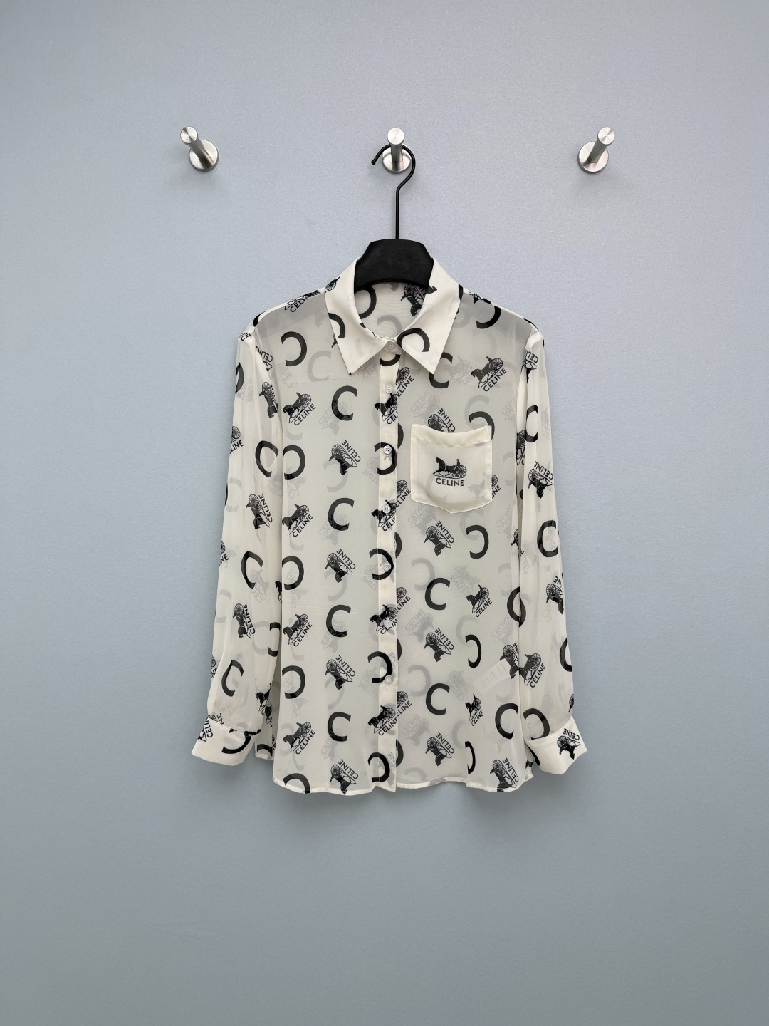 NO:781329,CELIN*26 new Arc de Triomphe carriage printed long-sleeved shirt is fully printed with CE's iconic carriage and letter pattern. It is low-key and recognizable, retro and fashionable. The lapel + single-breasted + pocket design retains the neatness of the shirt. The loose cut is comfortable but not tight, lazy and casual!  The horse-drawn carriage and big C logo are printed all over. It is retro and recognizable, and it does not look exaggerated at all. What I love most is that it is made of chiffon, which is light and breathable. The slightly transparent texture has a pure and lustful atmosphere, and it will not be stuffy when worn in summer. The loose version is very friendly to the figure, hides the flesh and makes you look slimmer. It is perfect for wearing alone, layering or as a sun protection shirt. It is a perfect all-purpose summer shirt!  2 colors and 3 codes SMLSS, Celine-clothing, celine, celine, shirts,19860909CELIN*26新款凯旋门马车印花长袖衬衣 满印CE标志性马车与字母图案,低调又自带辨识度,复古又时髦.翻领+单排扣+口袋设计,保留衬衫的利落感,宽松剪裁舒适不紧绷,慵懒又随性！满印的马车和大C logo,复古又有辨识度,完全不会显得浮夸. 最爱的是它的雪纺材质,轻盈透气,微透的质感自带纯欲氛围感,夏天穿也不会闷热. 宽松的版型对身材很友好,藏肉又显瘦,单穿、内搭或者当防晒衫都超合适,妥妥的夏日万能衬衫！2色3码SMLSS,赛琳-服装,celine,celine,shirts,,Women's clothing