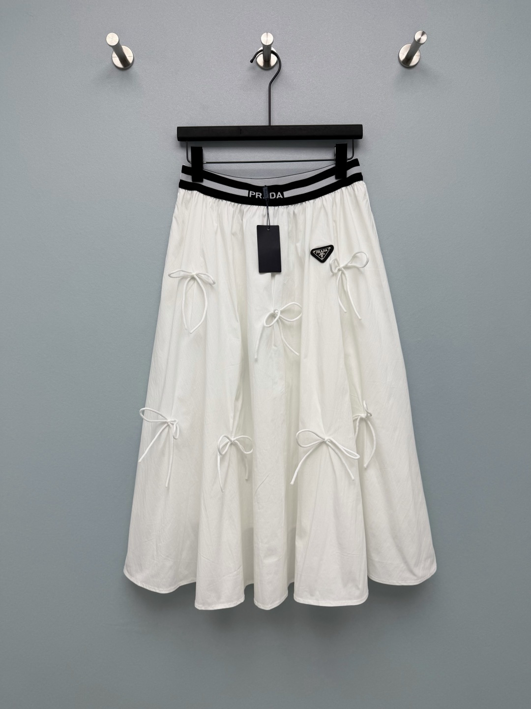 NO:828013,Prad*26 New Bow A-Line Skirt Waist Letter Elastic Ribbon  The bows of the same color distributed on the skirt add a sweet and cool girlish feel to the simple skirt, breaking the dull feeling and full of details. The A-line skirt naturally spreads out, perfectly covering the crotch and thigh flesh. It is super friendly to the pear-shaped body and has a slimming effect. The white color is refreshing and clean, and natural.  With a summer soft light filter, paired with a light-colored top, it looks super energetic; black is calm and slimming, paired with a dark top, it is neat and cool, suitable for a variety of styles and scenes ~ 2 colors and 4 sizes SMLXL, Prada-clothing, prada, prada, skirts,19860909Prad*26新款蝴蝶结A字半裙 腰头字母弹力织带 裙身分布的同色系蝴蝶结,为简约的半裙增添了甜酷少女感,打破了沉闷感,细节感满满.A字裙摆自然散开,完美遮住胯部和大腿肉肉,对梨形身材超友好,显瘦效果拉满.白色清爽干净,自带夏日柔光滤镜,搭配浅色系上衣超显元气；黑色沉稳显瘦,搭配深色上衣利落又甜酷,适配多种风格和场景~2色4码SMLXL,普拉达-服装,prada,prada,skirts,,Women's clothing