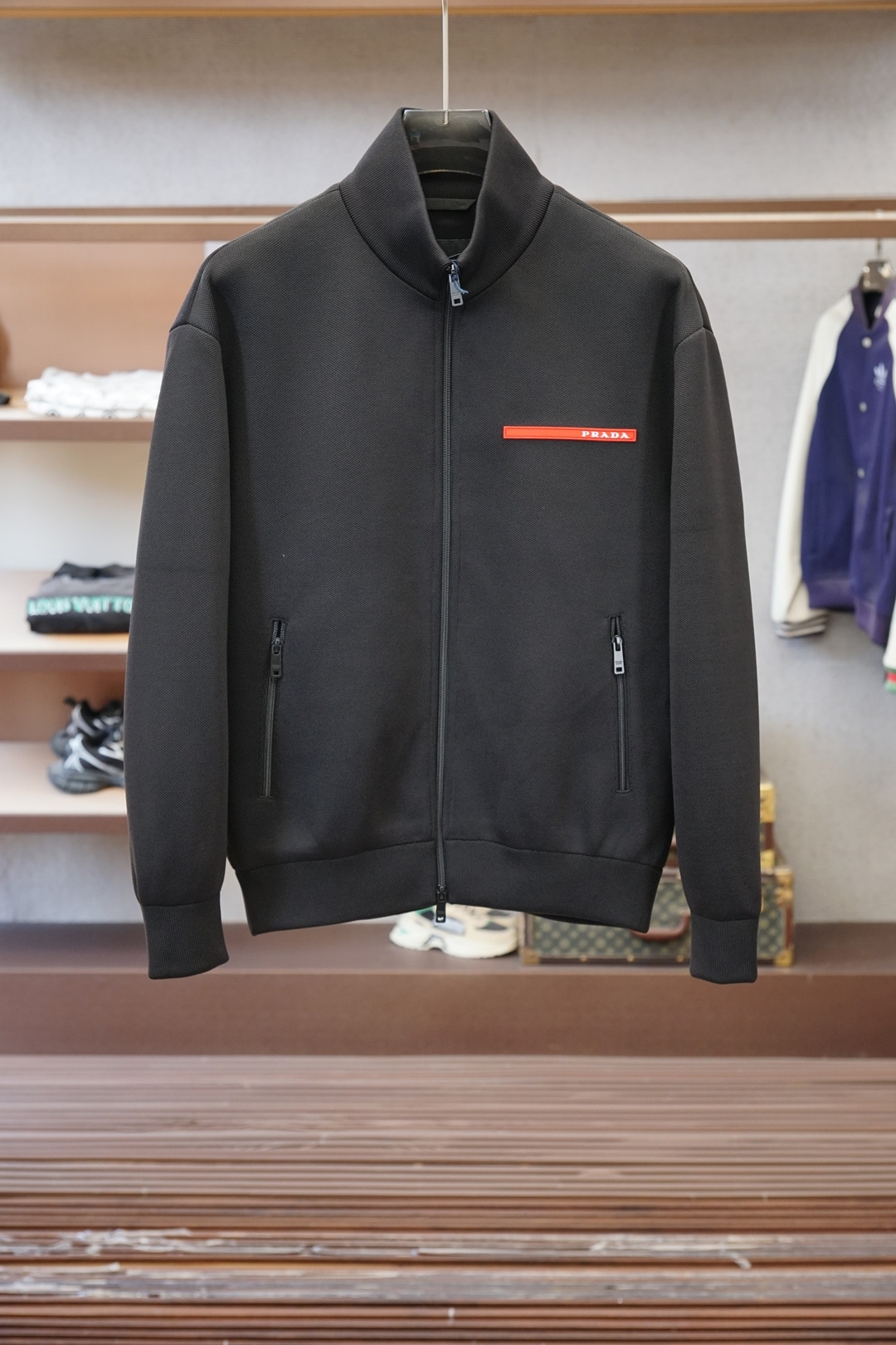 NO:623208,Prada/Prada-new product] P family’s latest men’s casual stand-collar jacket, a perfect blend of Italian craftsmanship and contemporary aesthetics!  Hong Kong trading company channel, exclusive sales!  -Materials and craftsmanship: The brand's unique pique texture fabric is used. The special texture presents a three-dimensional weaving effect. The elastic fiber blended material is selected to ensure wearing comfort while maintaining a crisp silhouette. The interior is lined with a skin-friendly lining, which is delicate to the touch and has good breathability. -Iconic design details. The brand's red silicone logo on the left chest is eye-catching. The precision zipper system has a customized metal puller engraved with 'PRADA MILANO', and the pull teeth are made of antioxidants.  Ribbed knitted hem and cuffs provide comfortable wrapping. Slightly expanded shoulders ensure freedom of movement - Suggestions for wearing scenarios: Urban casual with white T-shirt and casual trousers. Business casual with high collar knitted and chinos. Size selection: 48-58, prada, prada, jackets & coats, tees, t-shirt, alexander wang19860909普拉达/Prada-新品】P家族最新男士休闲立领夹克 ,意式工艺与当代美学完美交融！香港贸易公司渠道,独家销售！ -材质与匠心工艺 采用品牌独有的珠地纹理面料,特殊的肌理呈现出立体感的编织效果,精选弹力纤维混纺材质,确保穿着舒适度的同时保持廓形挺括 内里采用亲肤衬里,触感细腻且具备良好的透气性 -标志性设计细节 醒目品牌标识左胸处的品牌红色硅胶标识. 精密拉链系统定制金属拉头刻有「PRADA MILANO」字样,拉齿采用抗氧化 罗纹针织下摆及袖口提供舒适包裹性 肩部微扩剪裁确保活动自由度 -穿搭场景建议 都市休闲搭配白色T恤与休闲长裤 商务休闲内搭高领针织与斜纹裤 尺寸选择:48-58,,prada,prada,jackets & coats,tees，t-shirt,alexander wang,Men's clothing