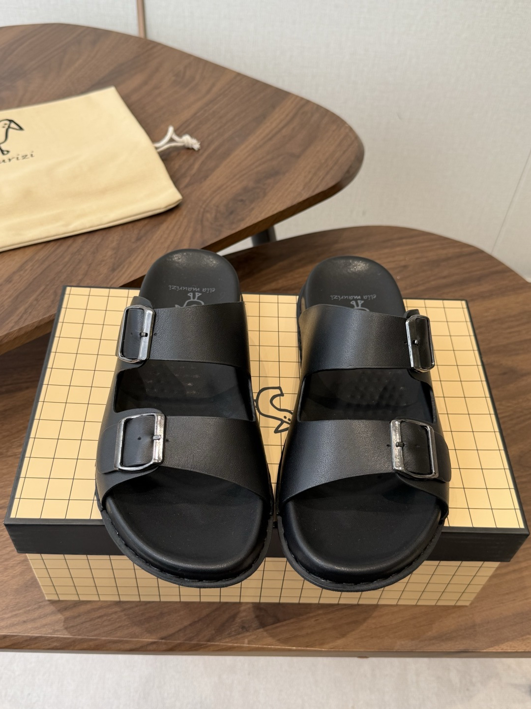 NO:816232,Wandan pure original Italian Elia Maurizi Elia men's casual sandals Elia Maurizi  Born in the small town of Montegranaro in the Marche region of Italy, it is a handmade shoe brand with three generations of heritage. Since its establishment in 2009, it has always been based on the craftsmanship of the family workshop, integrating traditional shoemaking techniques with contemporary minimalist aesthetics, insisting on using high-quality local Italian leather and environmentally friendly tanning techniques. Each pair of shoes is handmade by craftsmen, taking into account the concepts of comfort, durability and sustainability.  The whole body is made of matte black top-layer cowhide, retaining the natural texture of the leather, and has texture as you go. The neat double straps + adjustable metal buckle back strap design can be worn as slippers, suitable for a variety of foot types, taking into account the wrapping feeling and breathability. Handmade stitching outlines the outline of the shoe body, and the low-heeled thick-soled insole fits the arch of the foot, making it easy to walk for a long time. The all-black matte texture allows you to choose neither style nor outfit, and will keep you relaxed all summer. Who knows!  This pair of Italian handmade sandals puts 'effortless elegance' on your feet. Elia Maurizi, a niche brand from Italy's third-generation shoemaking workshop, really knows how to 'low-key and high-end'!  The brand was founded by Elia Maurizi, a designer of the same name. It is rooted in the handmade shoemaking tradition of the Marche region. It insists that each pair of shoes is handmade by craftsmen. It uses environmentally friendly tanning technology and local Italian leather to weld comfort and texture into the shoes. This pair of sandals fully embodies the essence of the brand.  The all-black matte cowhide texture is full, with no unnecessary decoration, but it comes with a cool and high-end filter. The design of the adjustable back strap can be perfectly adapted to wide and thin feet, and the soft thick-soled insole can drive and walk all day without scratching the feet. Whether worn with jeans, casual pants, or shorts, you can easily wear it with a relaxed Italian laziness. With three generations of shoemaking technology, a pair of black sandals can provide a sense of luxury throughout the summer, comfortable and wearing Italian shoemaking craftsmanship. Material: Original cowhide  Original rubber mold outsole, size 38-45, slippers, sandals, slippers, shorts, jeans, cowhide19860909莞产纯原意大利Elia Maurizi埃利亚男士休闲凉拖鞋 Elia Maurizi 诞生于意大利马尔凯大区的Montegranaro小镇,是拥有三代传承的手工制鞋品牌.自2009年创立以来,始终以家族工坊的匠心工艺为根基,将传统制鞋技艺与当代极简美学融合,坚持使用意大利本地优质皮革与环保鞣制工艺,每一双鞋履都由匠人手工打造,兼顾舒适、耐用与可持续理念. 通体哑光黑头层牛皮,保留皮革天然肌理,越穿越有质感,利落双带+可调节金属扣后绊带设计可以当拖鞋穿,适配多种脚型,兼顾包裹感与透气性 手工车线勾勒鞋身轮廓,低跟厚底鞋垫贴合足弓,久走无负担,全黑哑光质感,不挑风格不挑穿搭,承包你整个夏天的松弛感 谁懂啊！这双意大利手工凉鞋,把「不费力的贵气」穿在脚上 来自意大利三代制鞋工坊的小众品牌Elia Maurizi,真的太懂“低调高级感”了！ 品牌由同名设计师Elia Maurizi创立,扎根马尔凯大区的手工制鞋传统,坚持每一双鞋都由匠人手工打造,用环保鞣制工艺和意大利本地皮革,把舒适与质感焊死在鞋履里. 这双凉鞋更是把品牌的精髓拉满 全黑哑光牛皮质感拉满,没有多余装饰,却自带清冷高级滤镜.可调节后绊带的设计,脚宽脚瘦都能完美适配,软乎乎的厚底鞋垫,开车走路一整天也不磨脚.不管是配牛仔裤、休闲裤,短裤都能轻松穿出松弛的意大利慵懒感. 三代制鞋工艺,一双黑凉鞋承包整个夏天的高级感,舒适与把意大利制鞋匠心穿在脚下 材质面料原厂牛皮 原厂橡胶模具大底 码数38-45,拖鞋凉鞋,sandals,slippers,shorts,jeans,cowhide,Women's Shoes