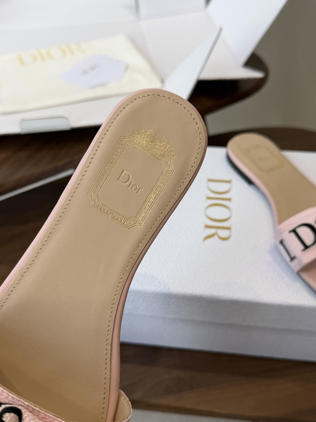 Dior26ss夏季新款字母织带平底一字拖鞋这双拖鞋以品牌标志性的字母织带打造，搭配同色系的皮质鞋床，简