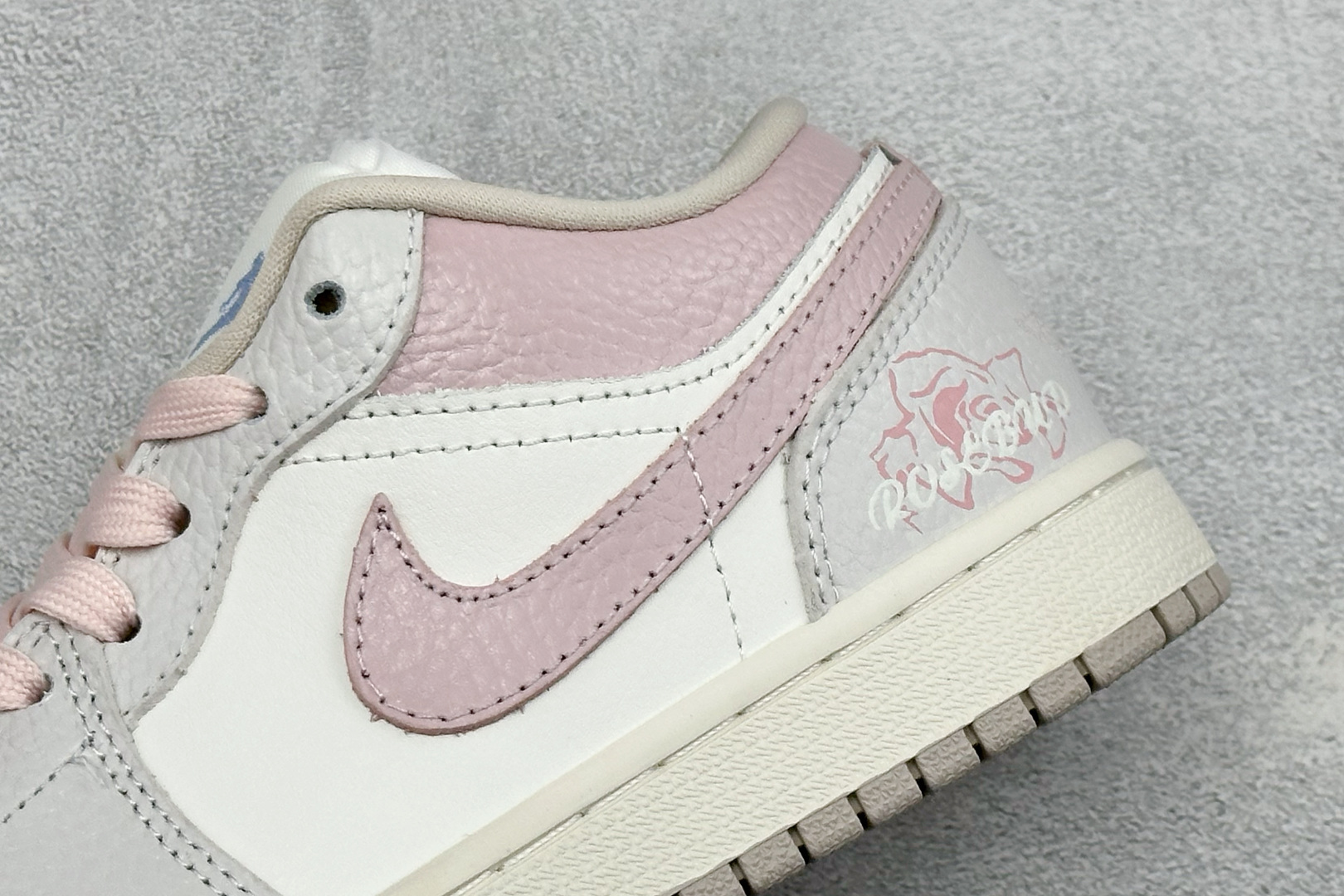 温柔甜妹颜值封神 AIR JORDAN 1，低帮简约鞋型搭配浅灰粉白柔和配色，细腻皮质质感出众，鞋后跟玫瑰刺绣精致浪漫，