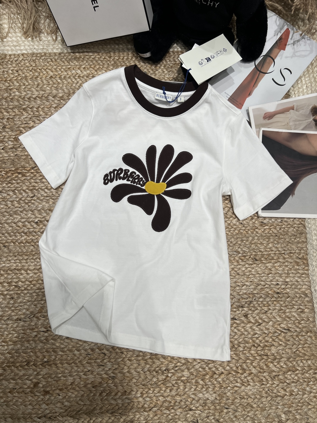 NO:830185,——Burber**——2026 SS daisy embroidered T-shirt, made of light plain woven cotton, soft and comfortable, suitable for daily wear. The daisy embroidery on the chest is matched with the brand logo, the details are exquisite, and the British style is full of contrasting collar. It is simple and energetic. Whether paired with jeans or casual pants, you can easily create a fashionable and casual style. It is suitable for commuting, dating, and vacation. SML XL, Burberry-clothing, burberry, loro piana, jeans, tees, t-shirt,19860909——Burber**——2026年SS雏菊刺绣T恤,采用轻盈平织棉,柔软舒适,适合日常穿着.胸前雏菊刺绣搭配品牌徽标,细节精致,英伦风满满撞色领口,简约又有活力,无论配牛仔裤还是休闲裤,都能轻松打造时尚休闲风,通勤、约会、度假都很适合哦,SML XL,博柏利-服装,burberry,loro piana,jeans,tees，t-shirt,,Women's clothing