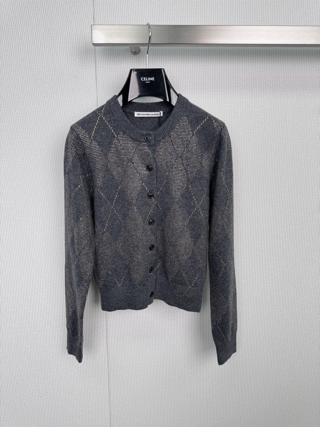 NO:588470,Alexander Wang 2025 autumn and winter new round neck hot diamond cardigan,  It is based on high-grade gray, with a rhombus pattern studded with brilliant hot diamonds. Each line is outlined by fine silver diamonds, and the light is refracted and shimmering. It perfectly balances lazy knitting and gorgeous details, hiding the philosophy of 'low-key publicity' and classic round neck design.  , with matte black resin buttons, an exquisite logo embroidered on the lower left hem, and can be layered with suspenders or shirts to create a layered look. Wear it alone for a lazy and casual look. Pair it with a coat to enhance the overall gloss. One piece is the code to unlock 'relaxed luxury wear'.  Code numberSML,,alexander wang,shirts,alexander wang19860909Alexander Wang亚历山大王2025秋冬新款圆领烫钻开衫, 以高级灰为底,菱格纹路缀满璀璨烫钻,每一道线条皆由细密银钻勾勒,光线流转间折射熠熠光芒,将慵懒针织与华丽细节完美平衡,暗藏「低调的张扬」哲学,经典圆领设计,搭配哑光黑树脂纽扣,左下方衣摆绣有精致logo,内搭吊带或衬衫皆可叠穿出层次感,单穿慵懒随性,搭配大衣提升整体光泽度,一件解锁「松弛感奢华穿搭」的密码. 码数SML,,alexander wang,shirts,alexander wang,Women's clothing