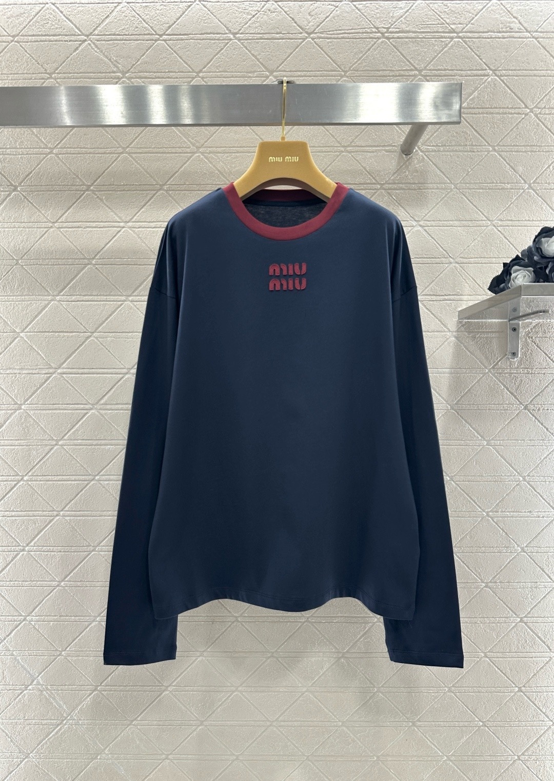 NO:710105,MiuMiu 2026 early spring series navy blue color-blocked long-sleeved T-shirt, soft knitted fabric, comfortable and close-fitting, dark red stitching on the collar + embroidered logo on the chest, retro and fashionable, loose fit, can be worn alone or layered, easy to create a casual sports style, the size is small, it is recommended to choose one size larger for more comfort~ It can be easily used for daily commuting and leisure occasions, it is a must-have and versatile item for early spring wardrobe!  Code number SML!  Code number SML,,miumiu,tees,t-shirt,19860909MiuMiu2026早春系列藏蓝拼色长袖T恤,柔软针织面料,穿着舒适贴身,领口暗红拼接+胸前刺绣Logo,复古又时髦,宽松版型,单穿或内搭都很OK,轻松打造休闲运动风,尺码偏小,建议选大一码更舒适哦～日常通勤、休闲场合都能轻松驾驭,是早春衣橱必备百搭单品！码数SML！ 码数SML,,miumiu,tees，t-shirt,,Women's clothing