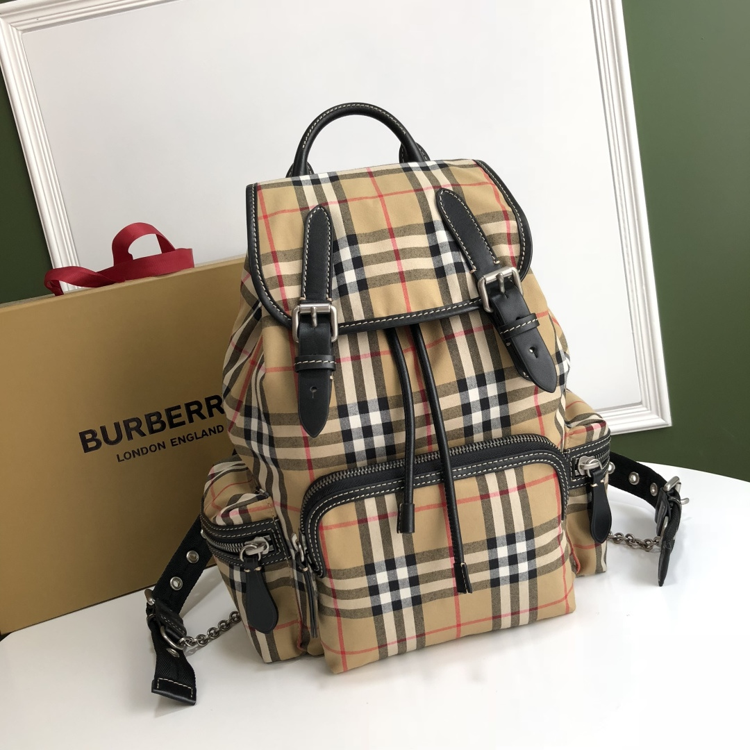 B Military Brigade backpack is crafted with meticulous attention to detail, inspired by the brand's classic military style design. It features a vintage checkered cotton fabric and is adorned with leather trim details. Model number: 112163, size: 22x33 cm. image 1