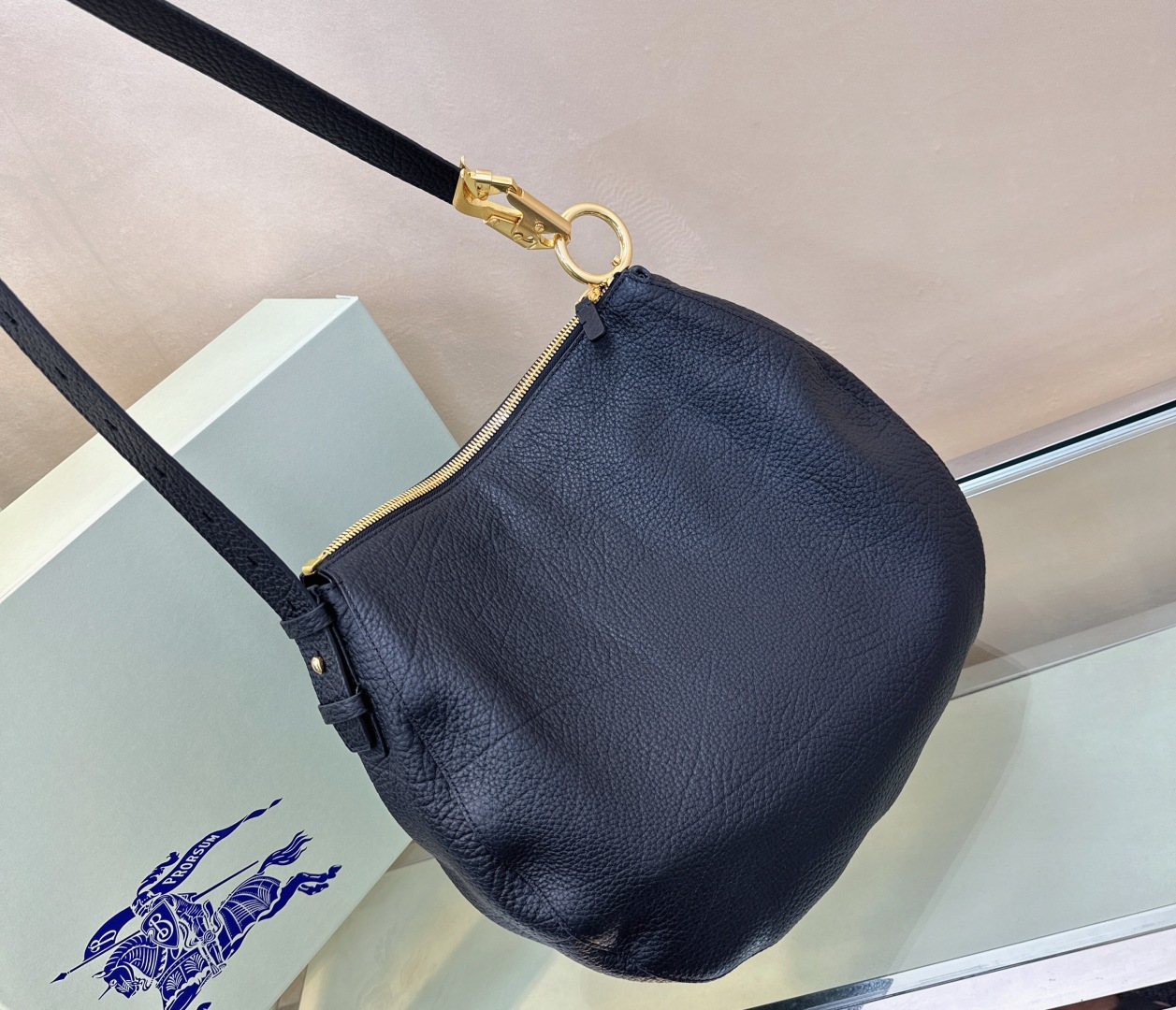 Burberry’s latest Cavalier War bag is made of grained calfskin fabric. Shoulder strap with