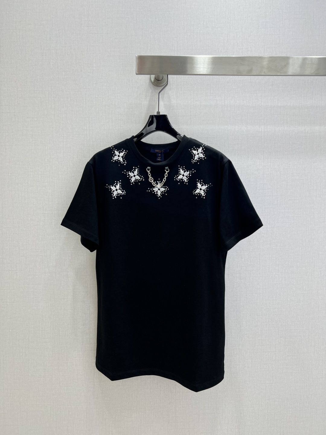 NO:687293,Highly recommended LV*2026 early spring new round neck beaded four-leaf clover chain short-sleeved T-shirt  Customized YB mercerized cotton material, breathable and comfortable, full of texture. Regular short-sleeved T-shirt cut. The simple black base makes the starburst diamond on the chest particularly eye-catching. The fine beaded surface shines brightly in the light and shadow. The design with metal chain adds a cool accent. The basic T-shirt instantly transforms into an eye-catching tool. It is versatile for daily wear but also hides a sense of casual sophistication. It is stylish when worn alone. Two colors  SML code high quality ABC,,louis vuitton,T-shirt,tees,t-shirt,19860909强烈推荐 LV*2026早春新款 圆领钉珠四叶草链条短袖T恤 定制YB丝光全棉材质,透气舒适,质感十足,常规短袖T恤裁剪,简约黑底衬得胸口的星芒烫钻格外亮眼,细碎订珠面在光影里漾出璀璨光泽,搭配金属链条的设计更添酷飒腔调,基础款T恤瞬间变身吸睛利器,日常穿既百搭又藏着不经意的精致感,单穿内搭都出彩时髦.两个色 SML码 高品质ABC,,louis vuitton,T-shirt,tees，t-shirt,,Women's clothing