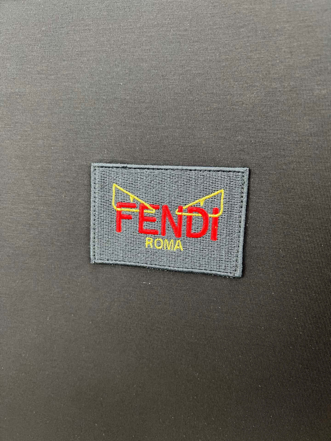  
FENDI 25春夏新品小怪兽刺绣徽章短袖T恤，正面胸前饰有FENDI Roma字样以及红色和金色F