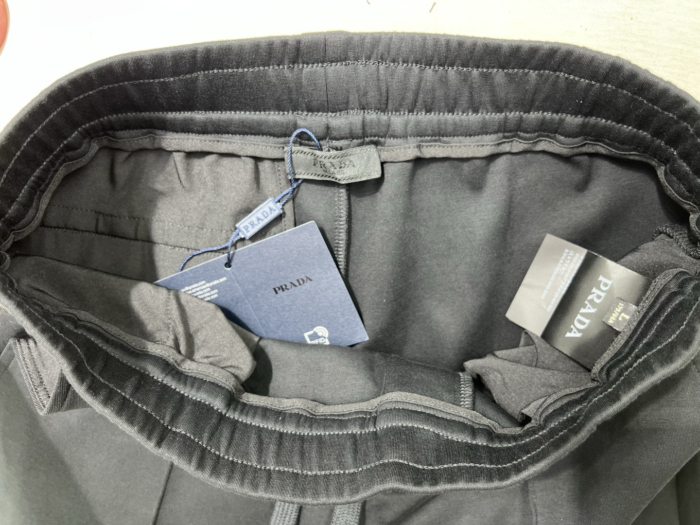 Prada.普拉达 25秋冬新品饰涂珐琅金属三角形徽标针织休闲长裤，正面两侧裤腿中位线条设计，背面袋口装