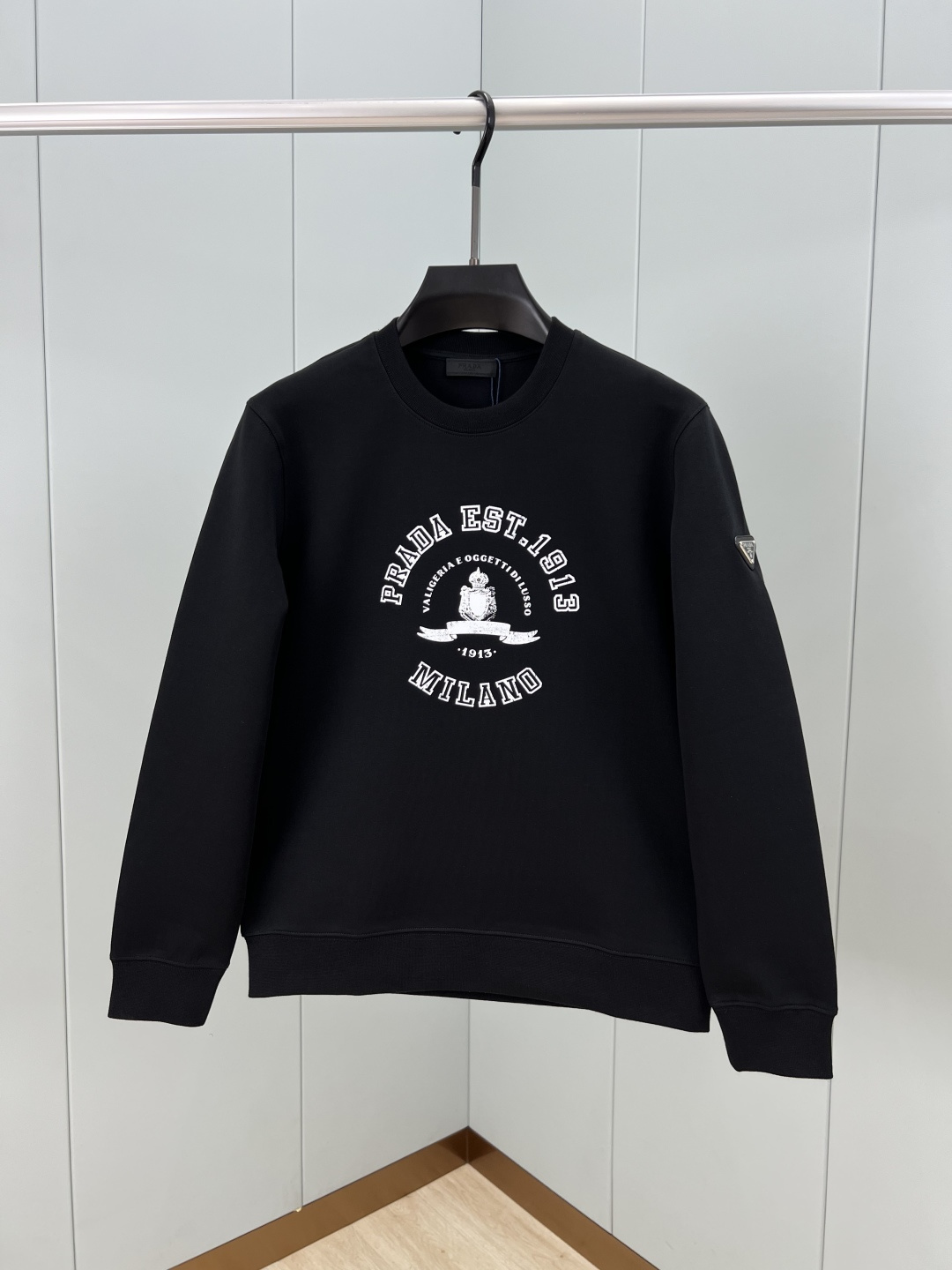 Prada.普拉达 25秋冬新品做旧印花标识针织圆领卫衣，左侧袖臂饰经典涂珐琅三角形金属徽标点缀，采用4