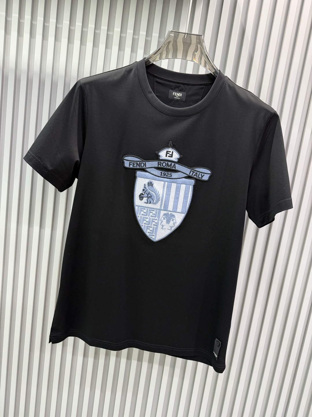 FENDI2026春夏系列的盾形徽章刺绣短袖T恤，设计风格兼具品牌经典元素与现代潮流感，适合日常穿搭或轻