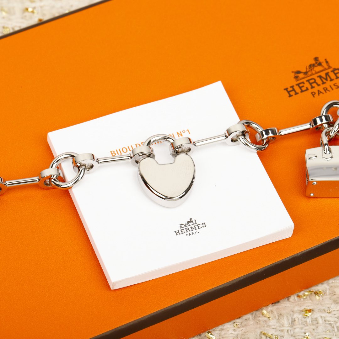 Hermes Bijou de Birkin N 1 bracelet Silver-toned metal with orange leather accents red enamel detail silver charms 17cm