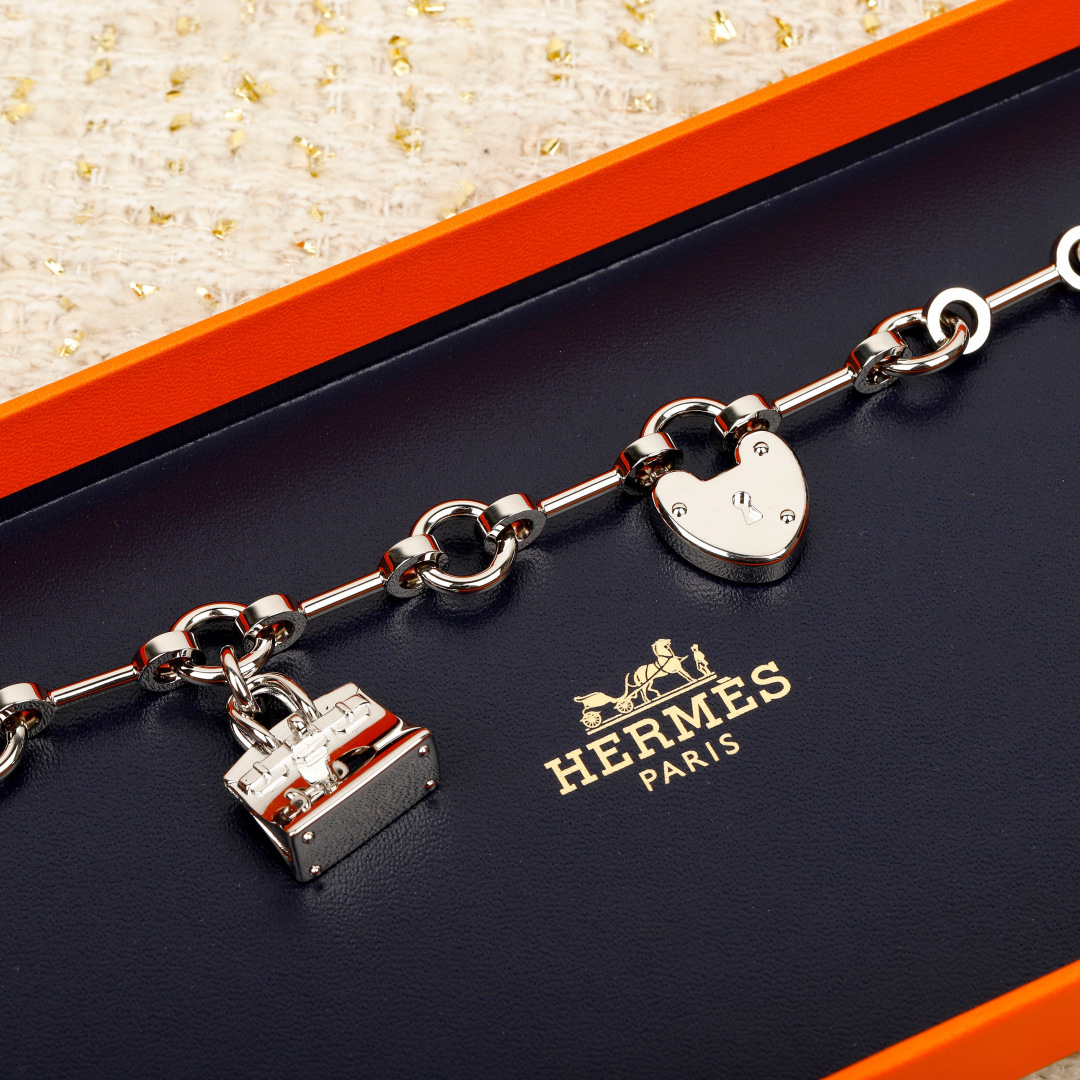 Hermes Bijou de Birkin N 1 bracelet Silver-toned metal with orange leather accents red enamel detail silver charms 17cm