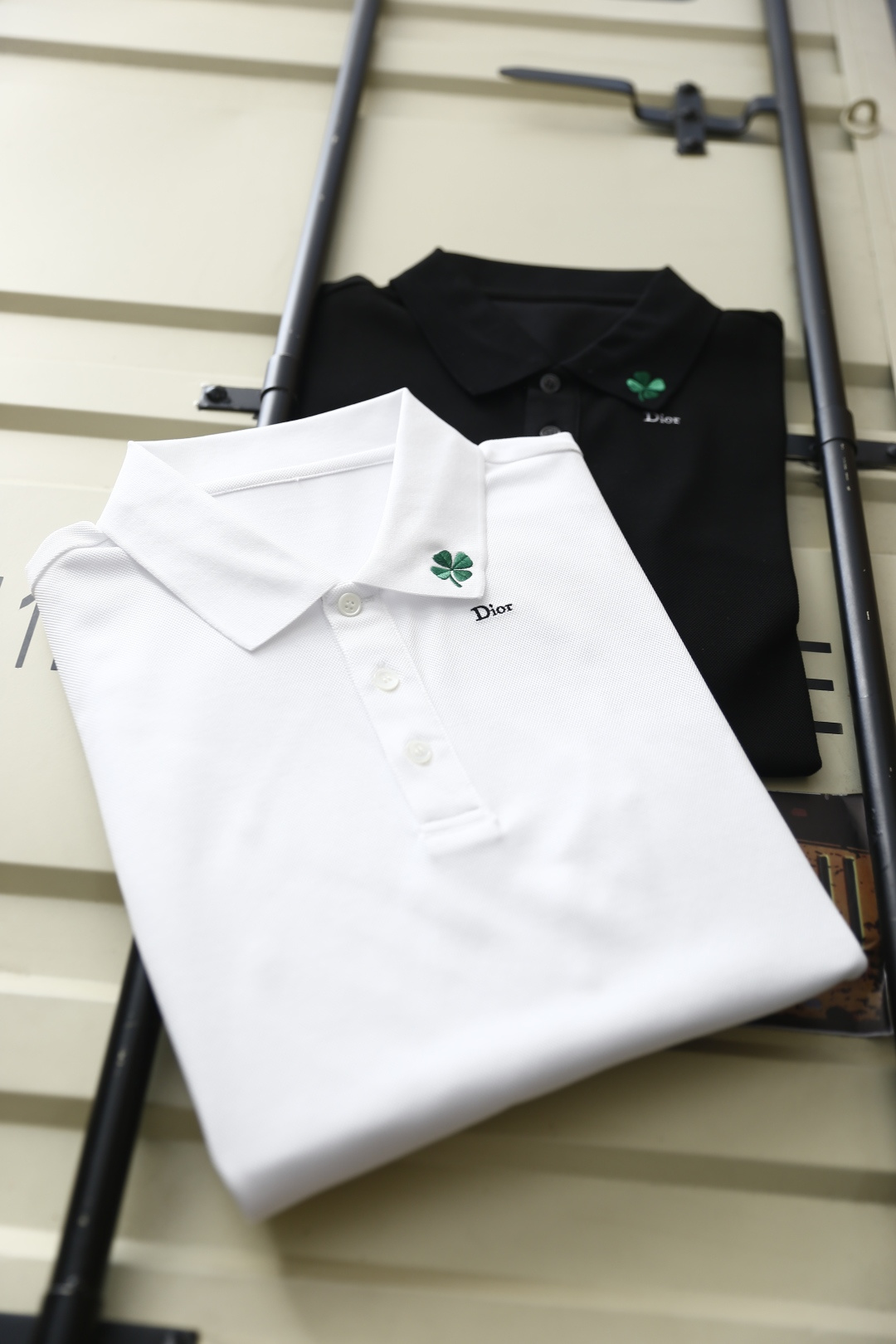 🔥迪奥.2026春夏新品男士短袖Polo衫采用经典翻领设计，门襟以多颗纽扣开合，线条简洁利落，版型规整修