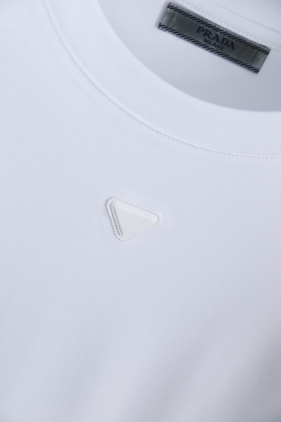 🔥普拉达.2026春夏新品男士短袖T恤采用经典圆领设计，领口线条流畅贴合颈部，版型宽松舒适，兼具休闲感与
