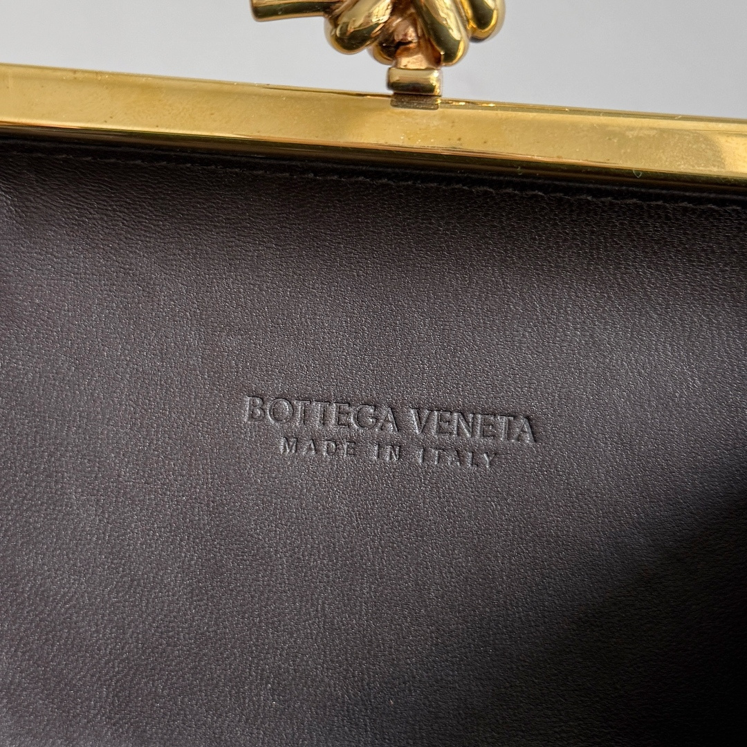 BOTTEGA VENETA2025 New Kont Banquet PackageWhen the natural texture of wood meets the brass edging, the BV dinner bag becomes a work of art in the fashion industry, with every grain of wood being a mark of time, delicate and unique. The brass metal buckle is adorned with starlight, creating a sense of ceremony when opened. It is the focus of the dinner party, able to easily store your exquisite small items. The warmth of the wood and the coolness of the metal collide, telling a niche and luxurious style in every gesture, allowing you to bloom with unique charm in every feast.Style number: 804292 (717622)Color: ChestnutSize: 20.5 * 6 * 12.5cm photo 5