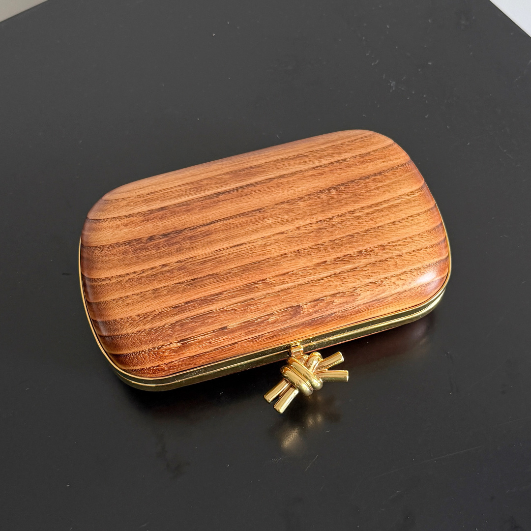 Shou Sugi Ban burnt cedar veneer, sheepskin leather lining, classic metal knot closure, texture details are both online.