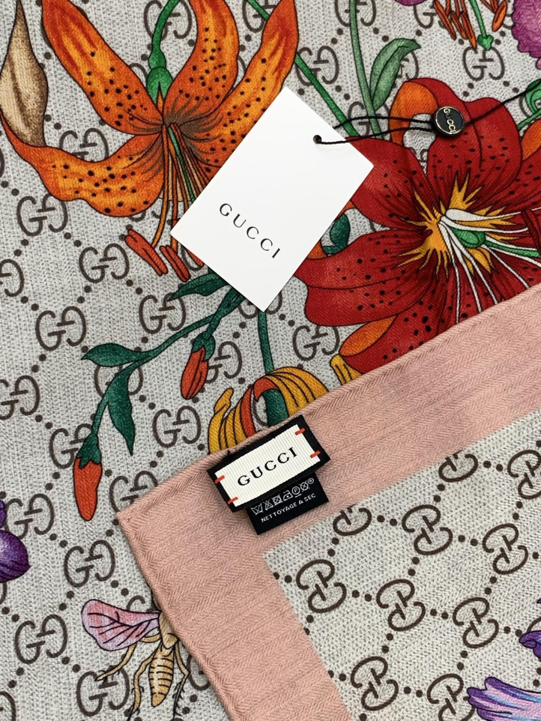 Gucci新款方巾 Gucci动物和花卉印花品牌典藏图案在与全新醒目印花的衬托下熠熠生辉。这款方巾匠心缀