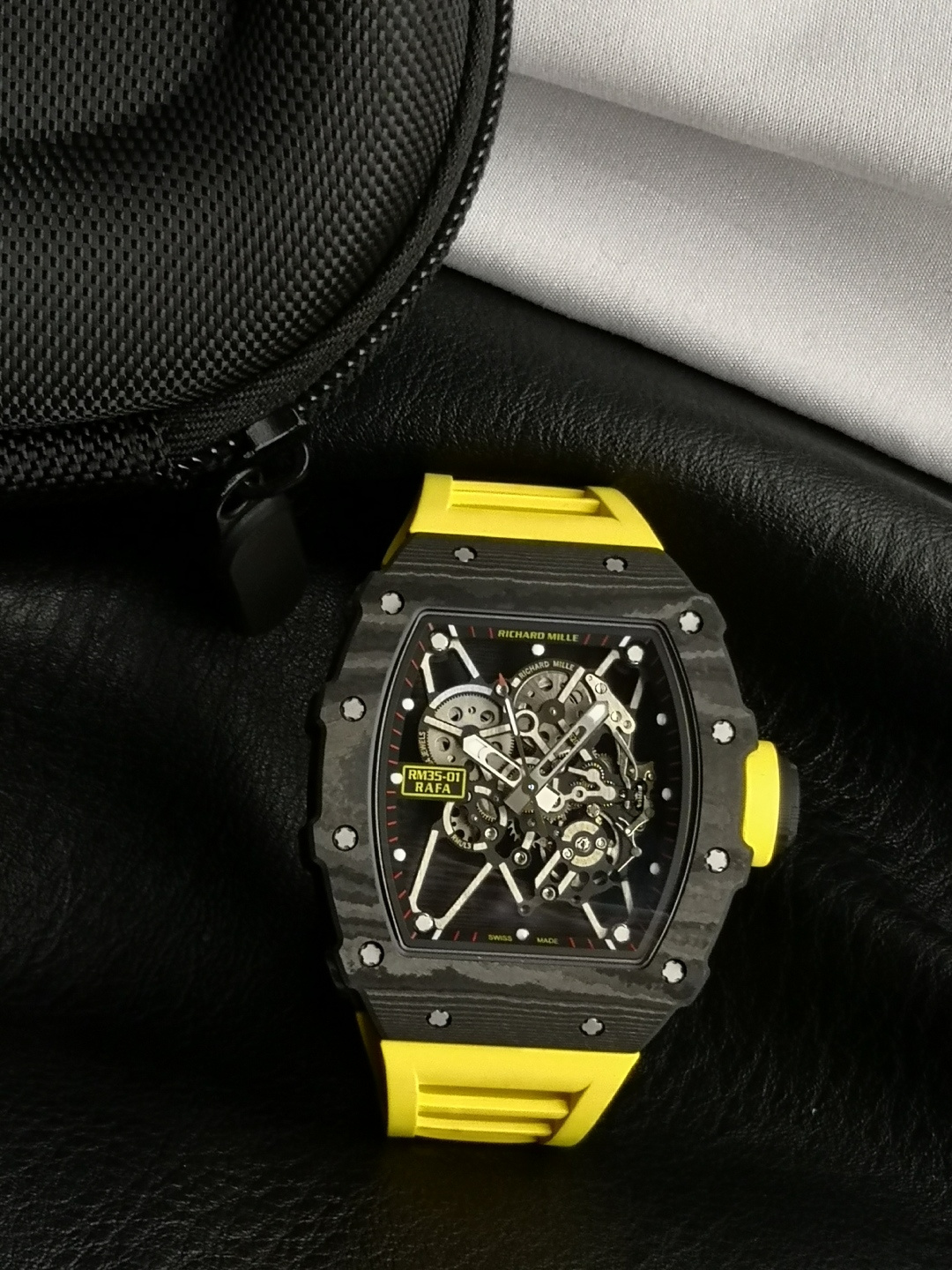 NO:858701,RICHARD MILLE Carbon TT composite carbon fiber produced by CK FACTORY - RM35-01 (dense bottom) ① The case is made of imported carbon fiber material, and the quartz line illuminates under strong light to match the original. ② Brand new all-in-one RMUL3 movement, the hollow manual winding movement is equipped with a double barrel system, and the balance wheel uses 2 white stones. ③ The dial and hands are made of Swiss luminous, and the luminous effect matches the original version.  ④The metal parts are made of titanium and synchronized with the original data. ⑤The case coding adopts one watch, one code, which is not a unified code. ⑥The strap material is made of aviation-grade fluororubber, and the colors of the first- and second-generation shark fin straps and watch handle rubber covers are freely selectable.19860909RICHARD MILLE Carbon TT 复合碳纤维 CK FACTORY出品—RM35-01（密底） ①壳套采用进口碳纤维材料,在强光下石英线发光对版原装. ②全新一体机RMUL3机芯,镂空手动上链机芯搭载双发条盒系统,摆轮上下真正使用2颗白宝石. ③表盘和表针采用瑞士夜光,发光效果匹配原版. ④金属部件均采用钛金属制作同步原装数据. ⑤表壳编码采用一表一码,非统一编码. ⑥表带材质为航空级氟橡胶制作,一代和二代鲨鱼鳍表带与表把胶套各颜色自由选择.,,Watch