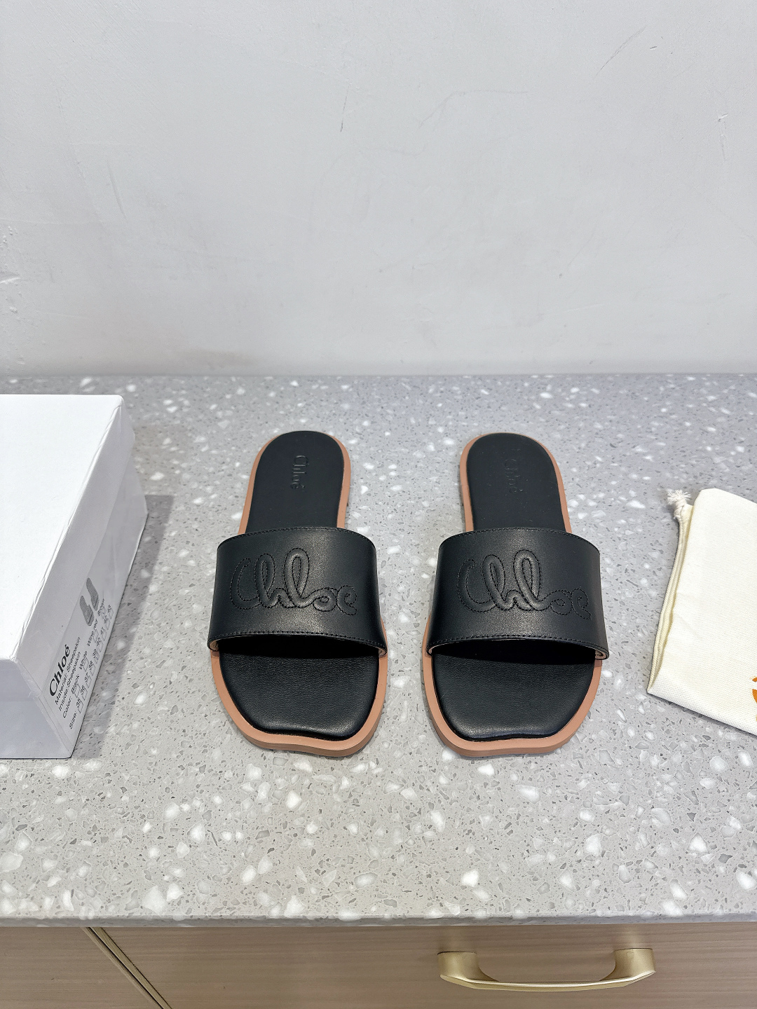 Chloe Coyle’s Classic Square Flat Slippers in Rubber and Skin Fashion.