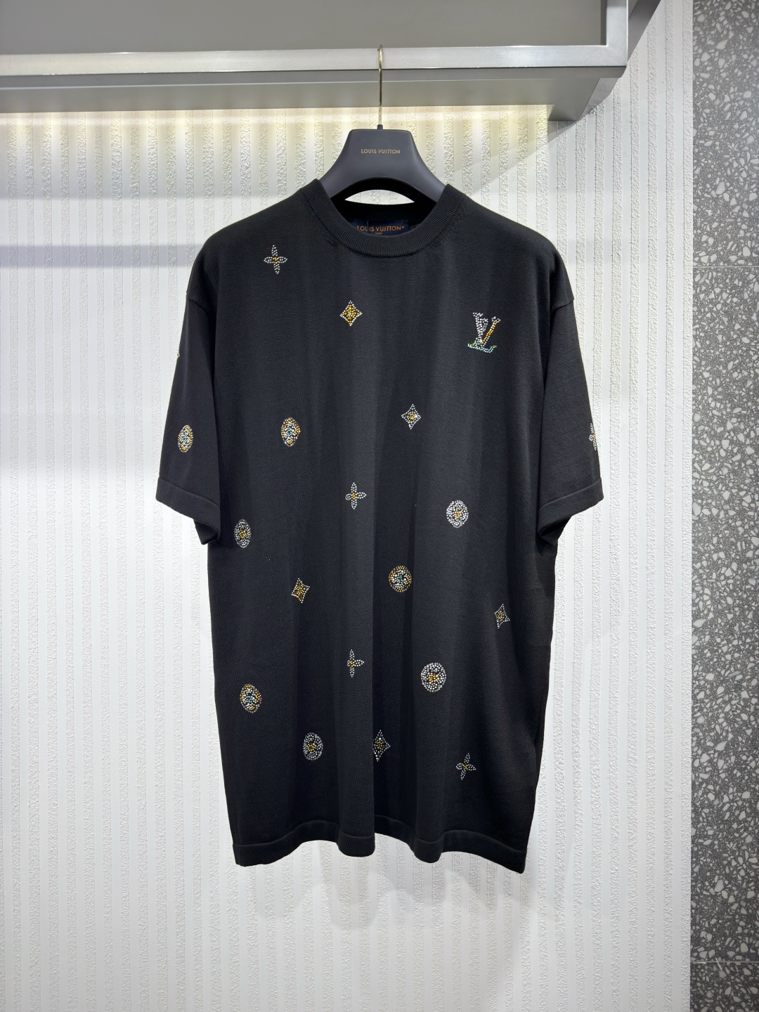 NO:777977,1V 26 Men's Hot Diamond Short Sleeve Floral Pattern Cotton Black Knitted T-Shirt Crewneck  This sophisticated black short-sleeved crew neck T-shirt is made from organic cotton and features the collection's signature LV floral pattern. Understated monogram floral detailing and the iconic LV signature adorn the front, sleeves and back, accented with bright and colorful rhinestones inspired by jewelry creations. It can be paired with other tonal garments for a strong and impactful look. Sizes S-XL, Louis Vuitton - Clothing, louis vuitton, louis vuitton, T-shirt, tees, t-shirt,198609091V 26 男装烫钻短袖花卉图案纯棉黑色针织T恤圆领衫 这件精致的黑色短袖圆领T恤采用有机棉制成,并饰以系列标志性的LV花卉图案.前襟、袖子和背面饰有低调的字母组合花卉细节和标志性的LV签名,配以鲜艳多彩的水钻,灵感来自珠宝创作.它可以与其他同色调服饰搭配,打造出强烈且具冲击力的造型.尺码S-XL,路易威登-服装,louis vuitton,louis vuitton,T-shirt,tees，t-shirt,,Women's clothing