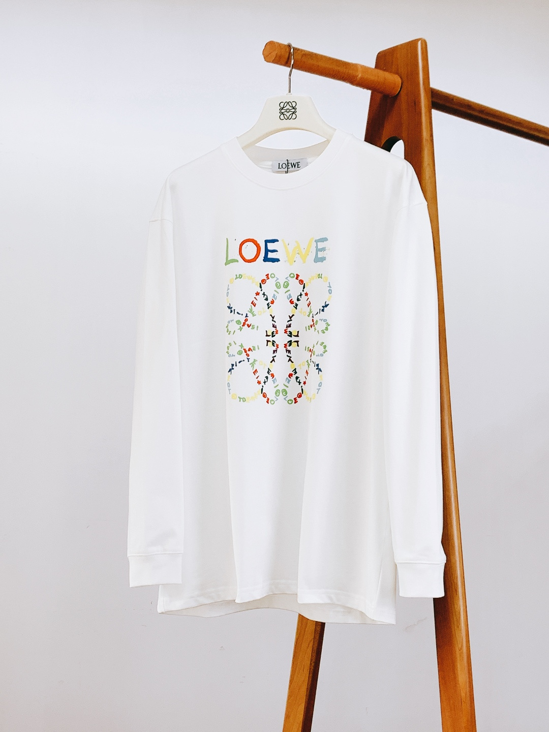 NO:599639,Loewe's new 2025FW autumn and winter graffiti printed bottoming shirt. The hand-painted graffiti letters + brand logo on the chest, and the color collision bring a 'vivid artistic sense', making it a luxury brand that can be remembered at a glance. The high-count cotton fabric is soft and breathable, fits the skin without pressure and is not easy to deform. The ribbed details on the collar/cuffs reveal the exquisite Spanish craftsmanship.  The basic round neck style is a 'relaxed artistic style' when worn alone, and can be worn layered with a suit/denim jacket. The black and white two-tone color is suitable for all scenes. The base material is just right in thickness and suitable for spring and autumn alone or as an inner layer in autumn and winter. It is a high-end basic style that 'enhances the freshness of the outfit'. ……………………………………………… SizeM-3XL,, loewe, loewe, jackets & coats, business suit, alexander wang19860909Loewe 罗意威 2025FW秋冬新品 涂鸦印花打底衫.胸前手绘感涂鸦字母+品牌标识,色彩碰撞自带“鲜活艺术感”,是一眼就能记住的奢牌辨识度. 高支棉面料软而透气,贴肤无压还不易变形,领口/袖口的罗纹细节,透着西班牙工艺的精致. 基础圆领版型,单穿是“松弛艺术风”,叠穿西装/牛仔外套又能穿出层次感,黑白双色适配全场景穿搭. 厚度刚好的打底材质,春秋单穿、秋冬内搭都合适,是“一件提升穿搭鲜活度”的高阶基础款. …………………………………………………… SizeM-3XL,,loewe,loewe,jackets & coats,business suit,alexander wang,Men's clothing