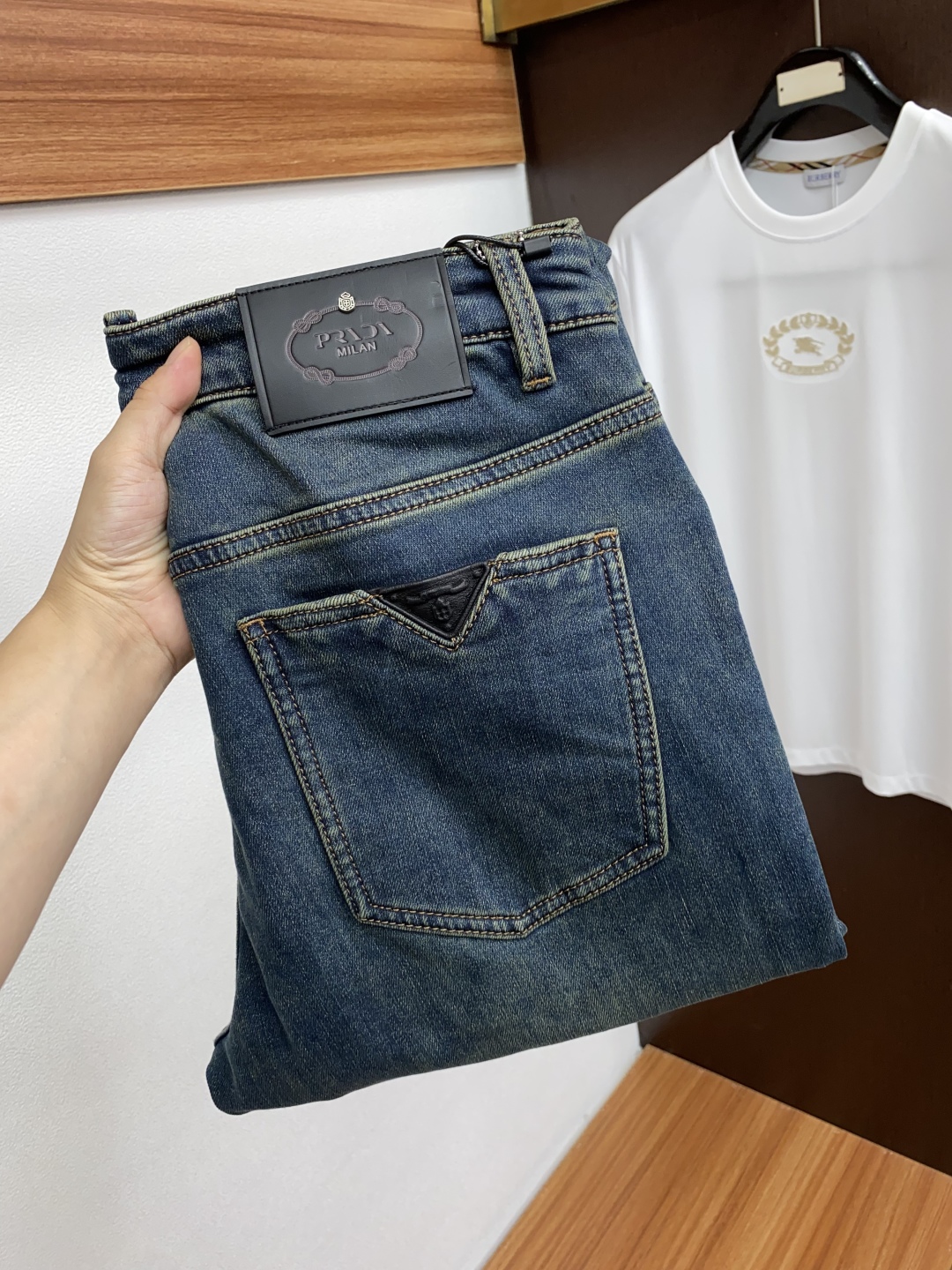 “Prada Men’s Fall/Winter Jeans: Durable, Handcrafted, Unique Design with Leather Plates and Metal Accents”
