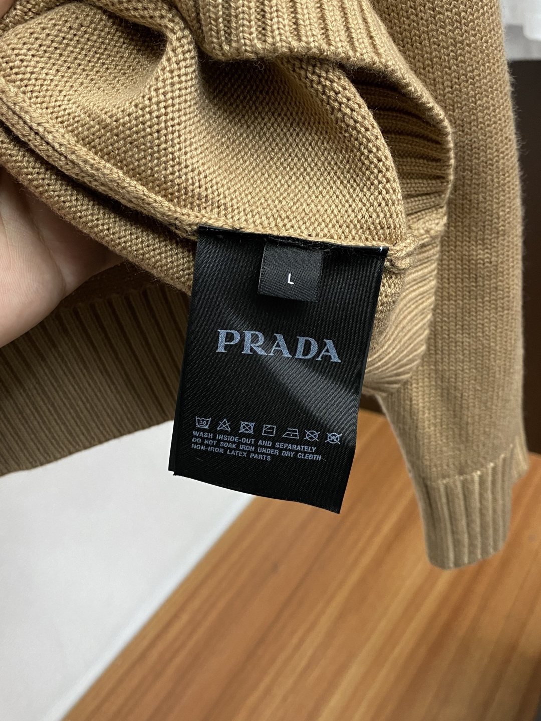 普拉达 羊毛混纺针织衫1.羊毛羊绒混纺面料：精选高品质的羊毛与羊绒原料，按照一定的比例进行混纺。羊毛提供