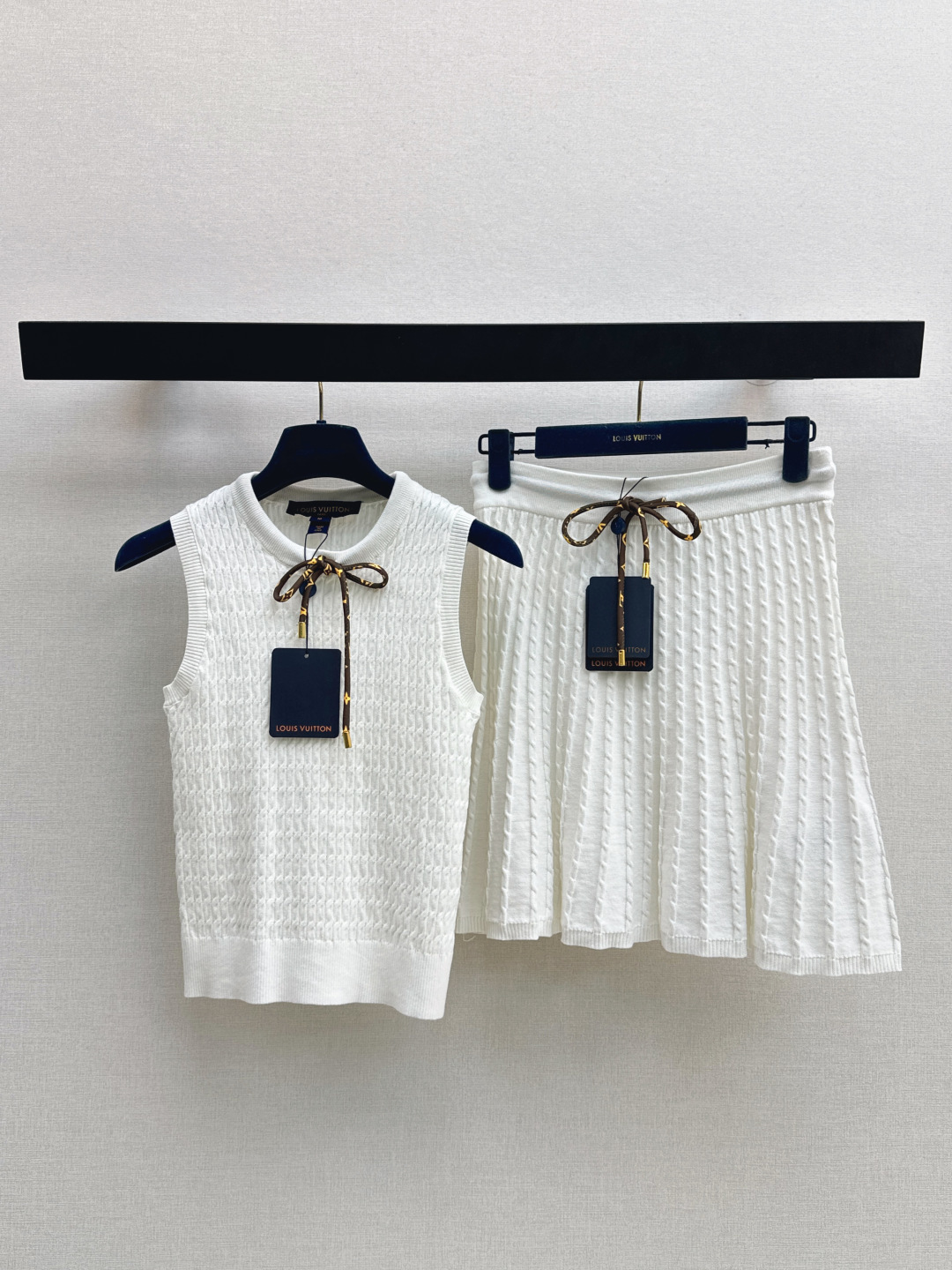 NO:845203,L Family 26Ss————The latest spring and summer age-reducing vacation series presbyopic suit bow cable knitted vest + pleated skirt. Elegant and pure cable knitted suit at first glance. Retro cable texture with brown presbyopic bow tie embellishment is simple and advanced. The color scheme of the milky breath is too fairy. Imported machine to create three-dimensional fine twist cable knitted surface. The texture is full of uneven texture. Developed in one color. Ready for sale sml top 91230180  skirt,,louis vuitton,skirts,19860909L家 26Ss————春夏最新款减龄度假系列老花套装蝴蝶结绞花针织背心+压褶半裙 一眼优雅纯欲绞花针织套装 复古绞花肌理搭配棕色老花蝴蝶结系带点缀简单又高级 奶呼呼的配色也太仙了 进口机打造立体精细麻花绞花织面 凹凸有致的肌理质感满满 一色分开发 现货发售sml 上衣91230180 半裙,,louis vuitton,skirts,,Women's clothing
