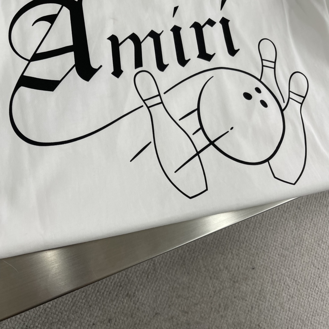 

-Amiri的白色T恤，简约中带着满满的个性。干净的白色底色，给人一种清爽的感觉。
背后大大的“Am