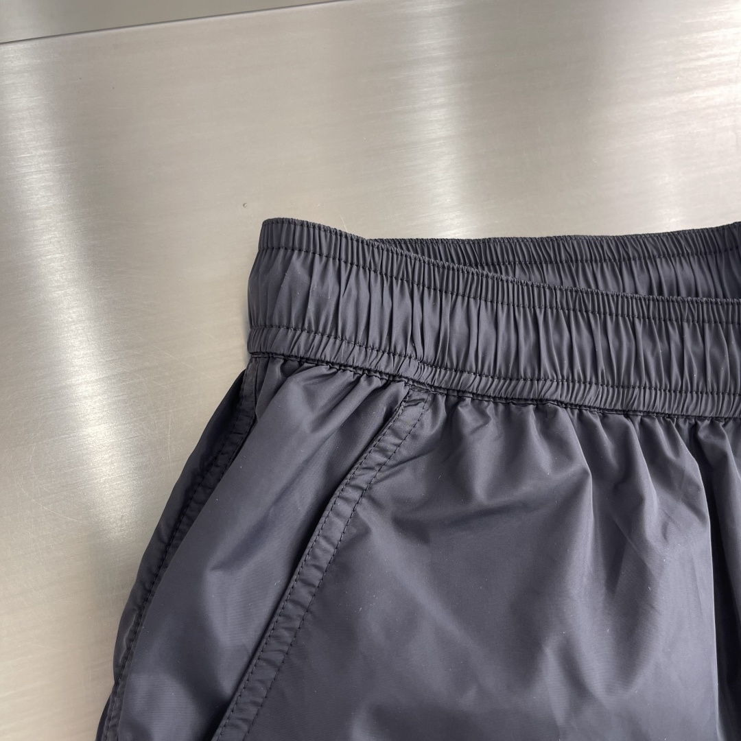 -mon 织带式短裤，这款短裤采用再生面料制作而成，侧口袋饰有红蓝式经典织带，松紧腰头搭配有橡筋抽绳，金