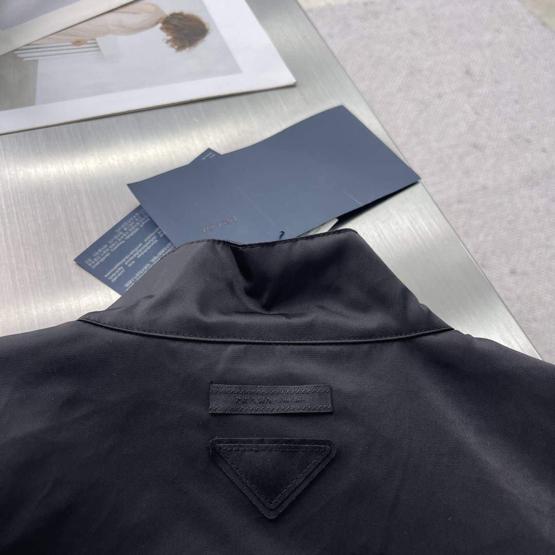 -PRAD 25fw秋冬新款立领夹克采用再生尼龙制作而成，立领系扣，内里有袋，后背有三角标织物，前幅拉链