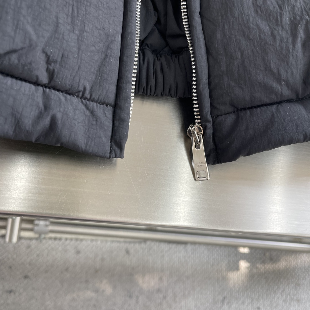 -PRAD 刺绣标识拉链棉服外套采用60支100%磨毛尼料，面料为定织款。刺绣采用3D立体刺绣，小log