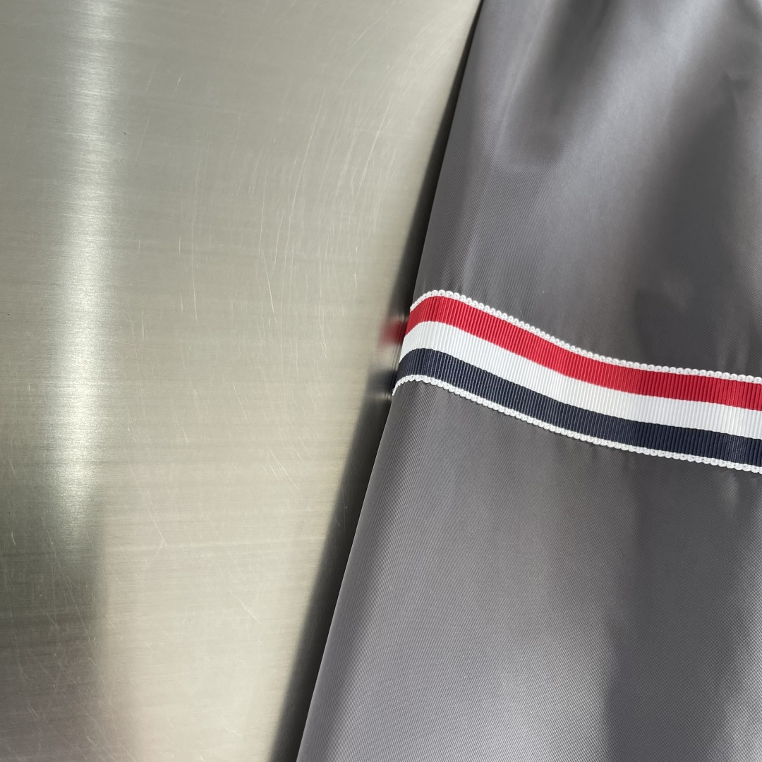 -TB 双袖标连帽冲锋夹克经典纽约标识融合在这件连帽夹克，把高奢细节缝进了通勤松弛感里。胸前户外反光四道